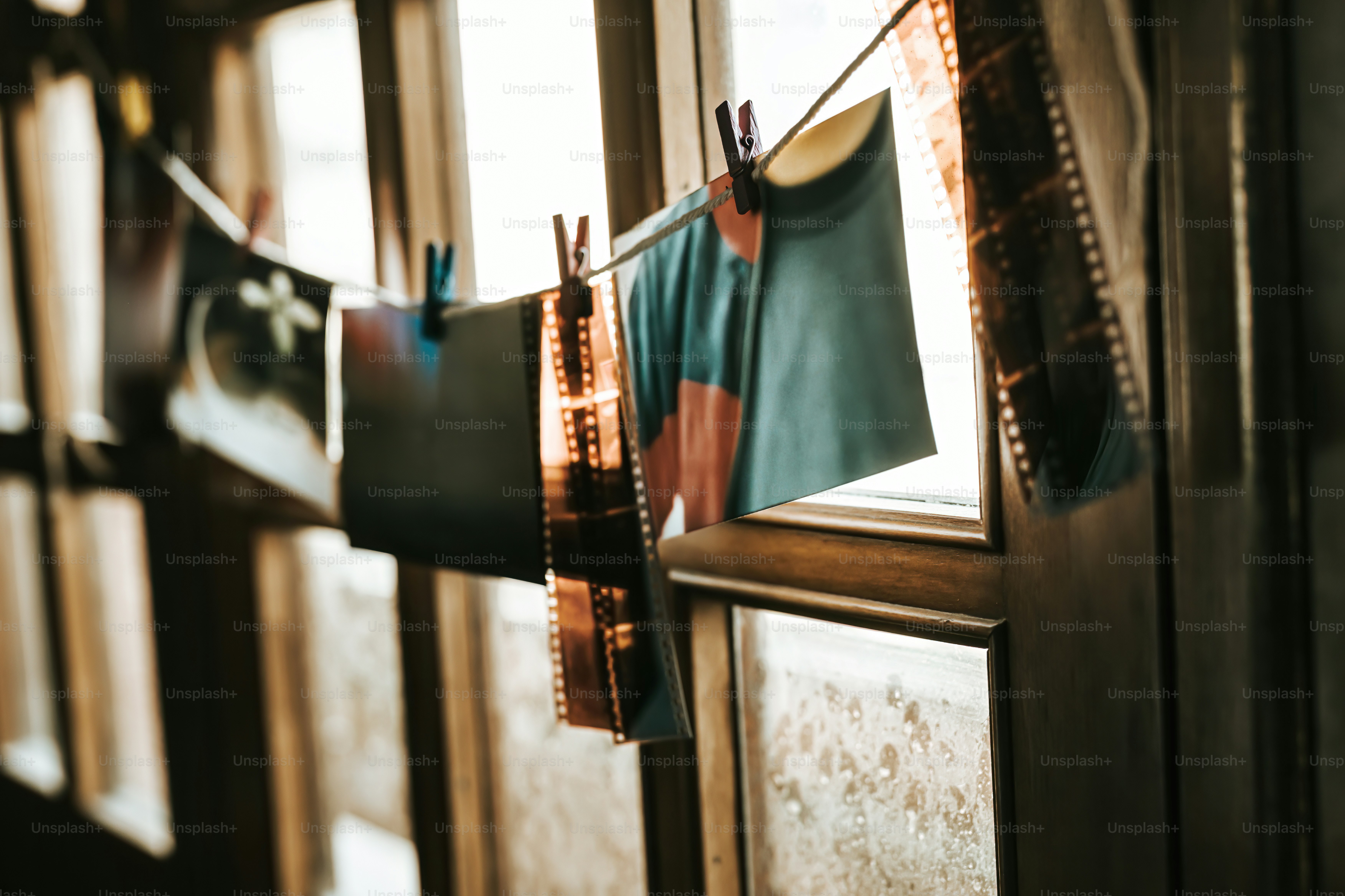 clothes hanging on a clothes line in front of a window