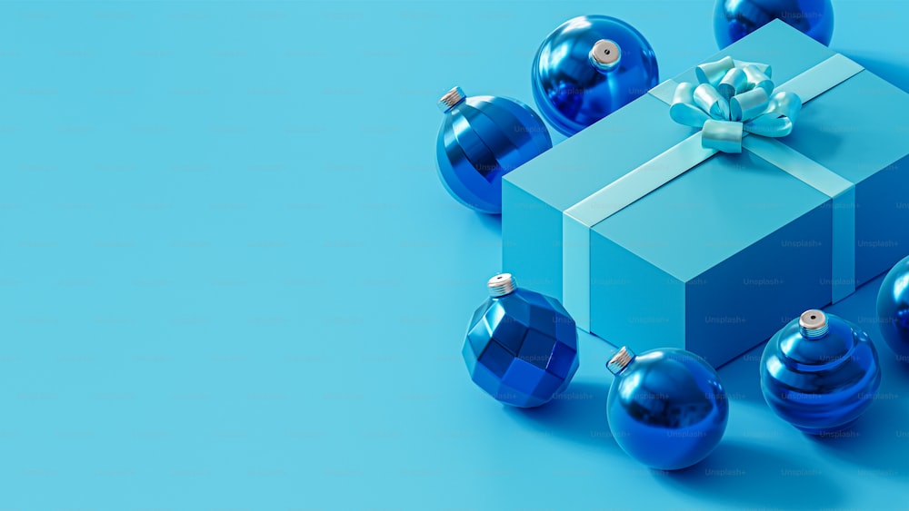 une boîte cadeau bleue avec un nœud et des ornements autour