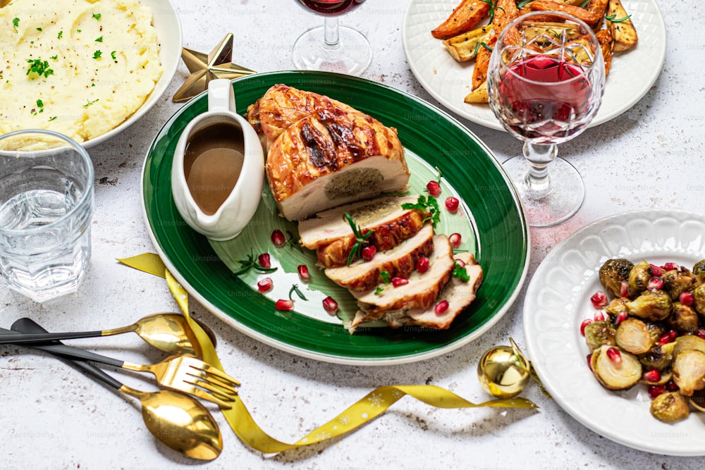 a table with plates of food and glasses of wine