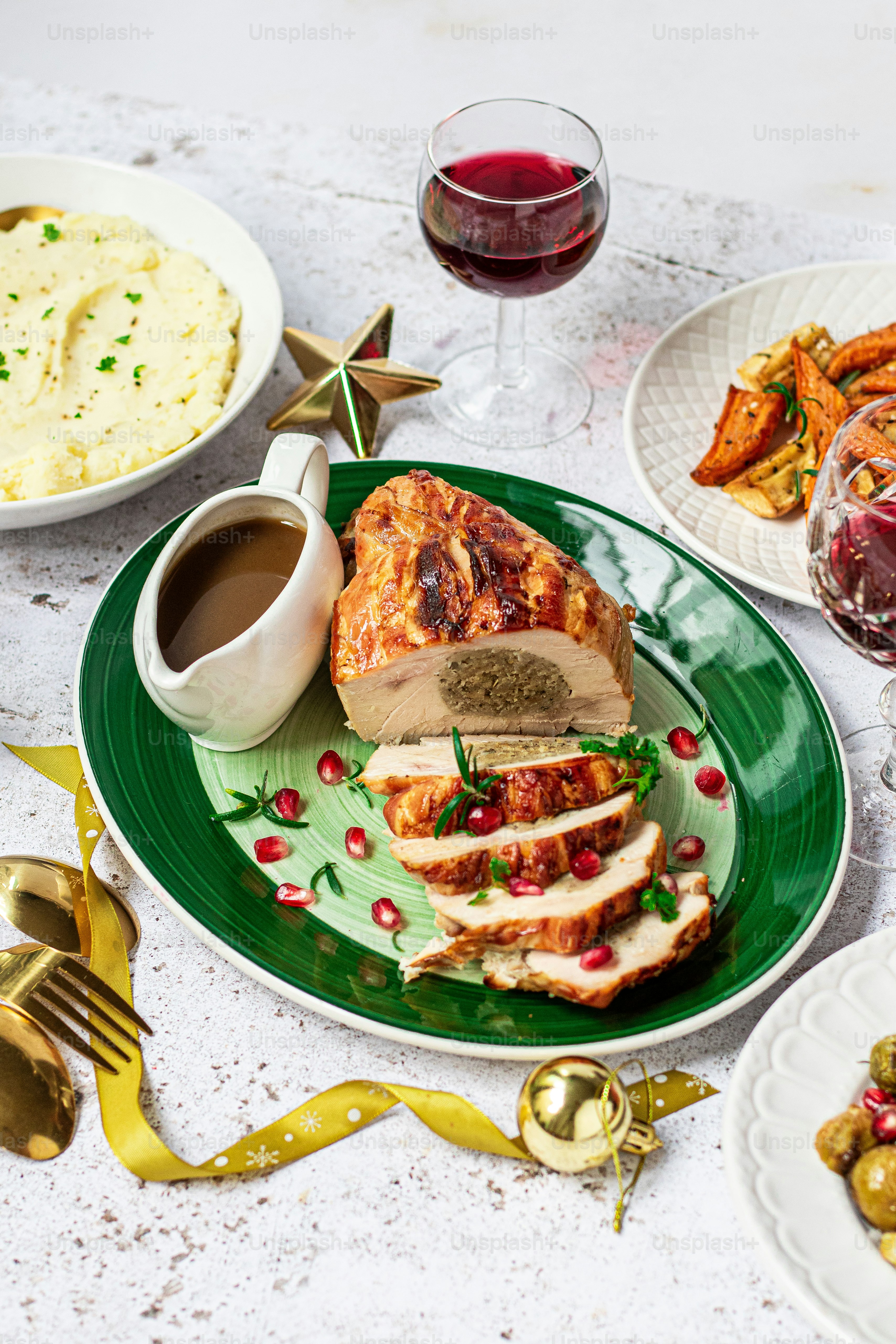 a green plate topped with meat next to a bowl of mashed potatoes