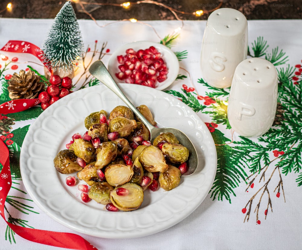 a plate of roasted brussel sprouts with pomegranates