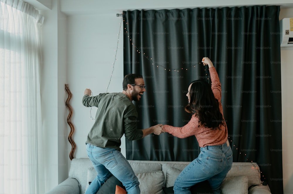 a man and a woman dancing in a living room