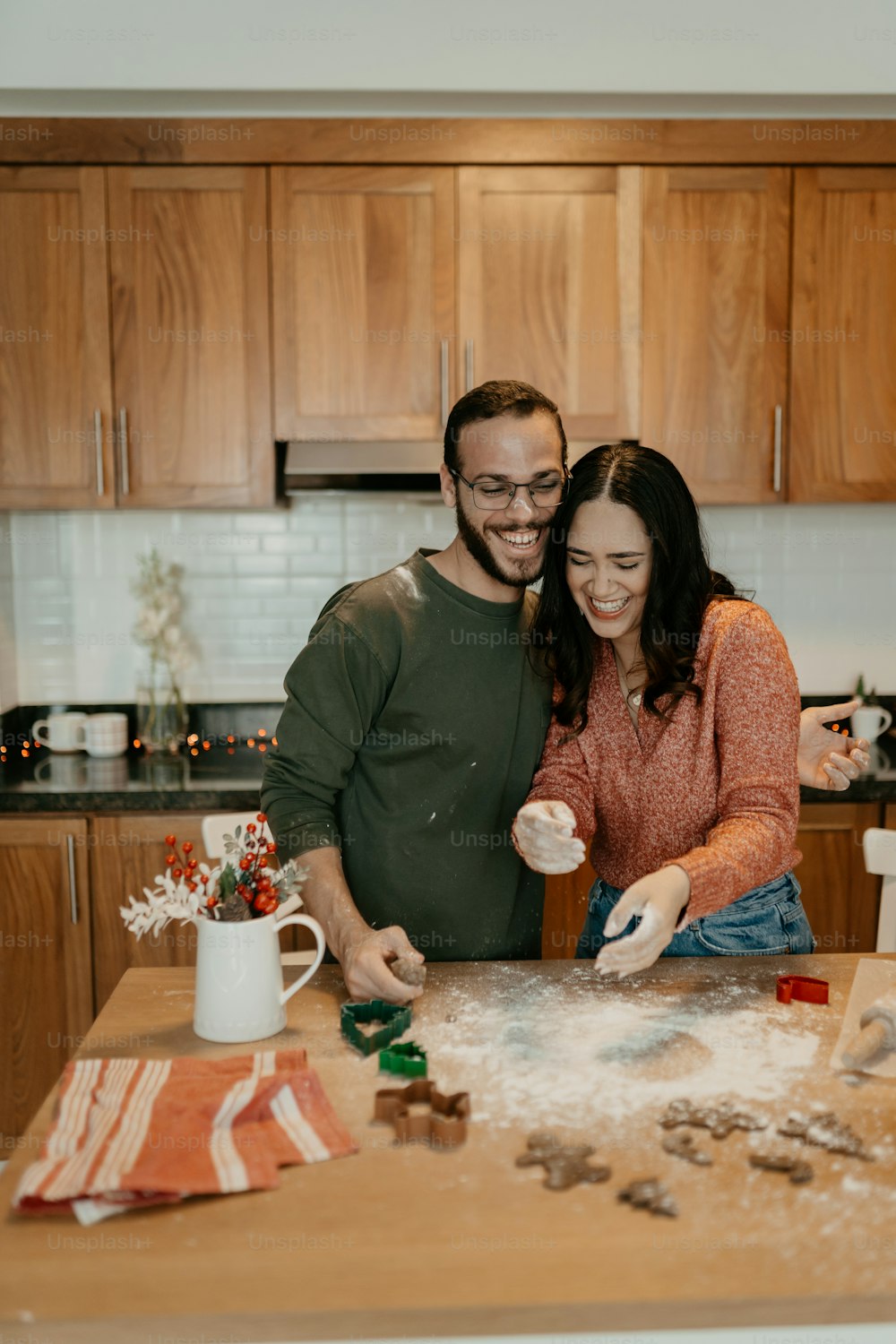 a man and a woman are making cookies together