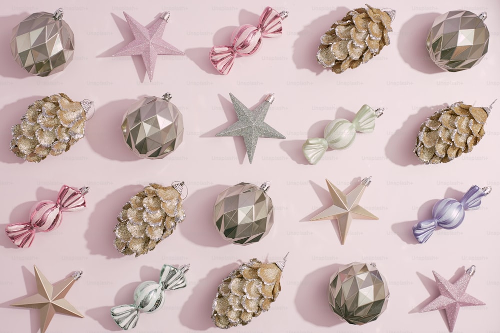 a collection of christmas ornaments on a pink background