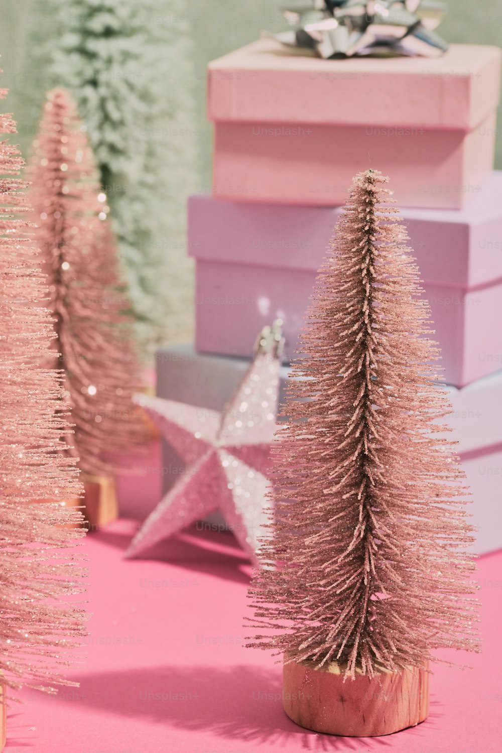a pink table topped with pink christmas trees