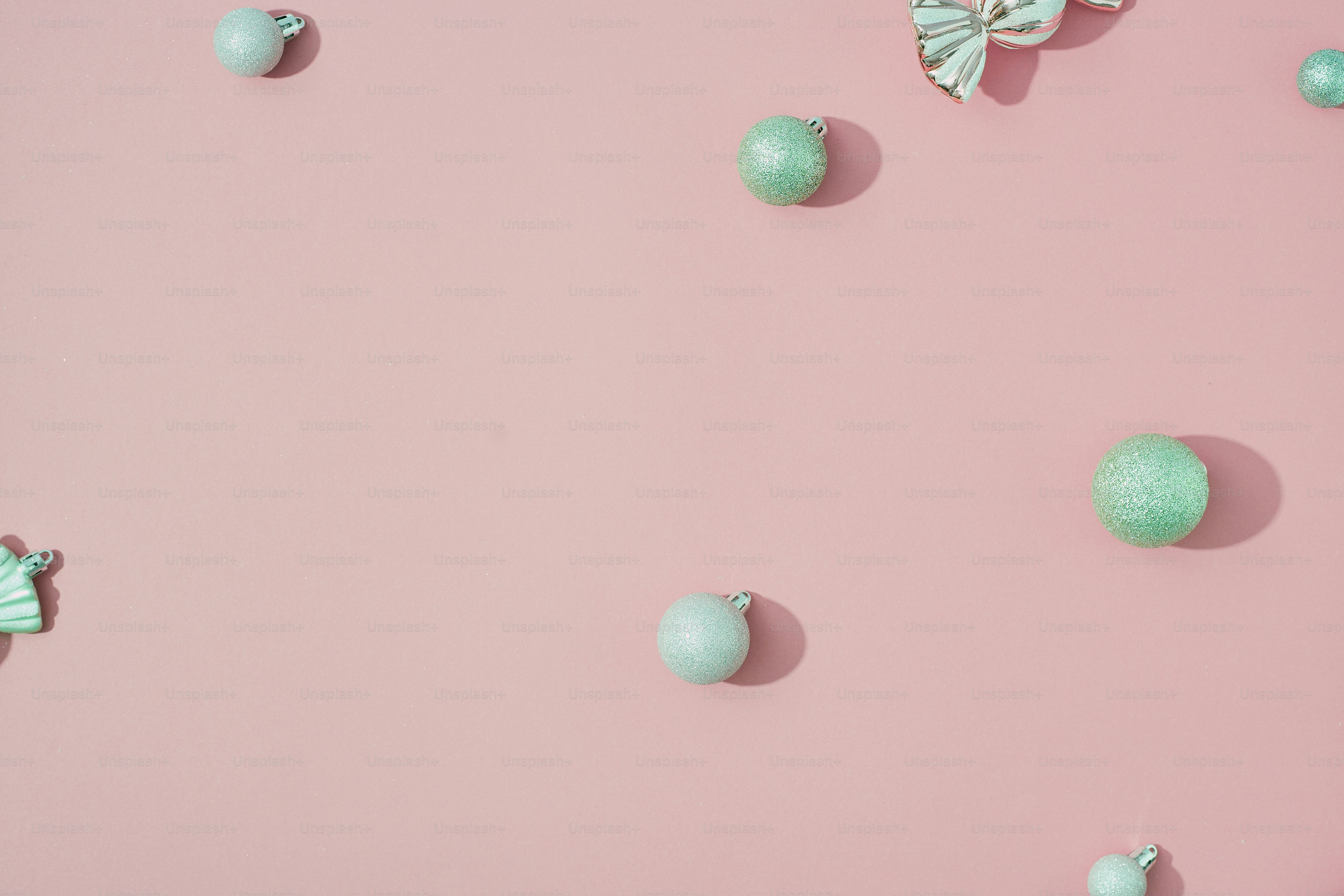 a pink background with green balls and butterflies