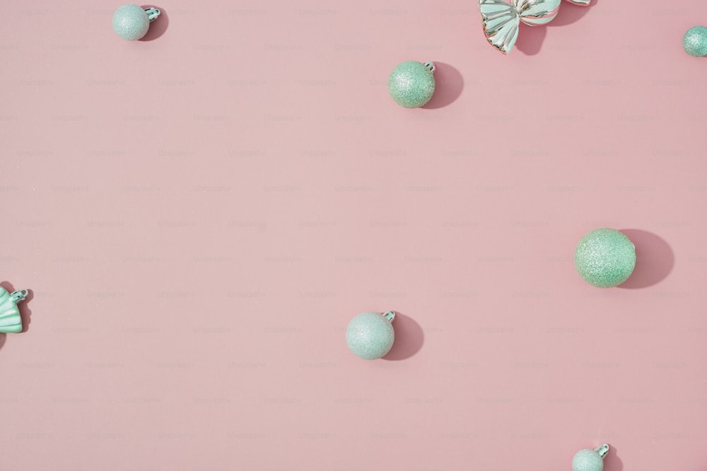 a pink background with green balls and butterflies