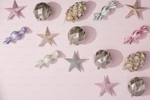 a group of star shaped objects on a pink surface