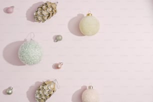 a group of christmas ornaments on a pink background