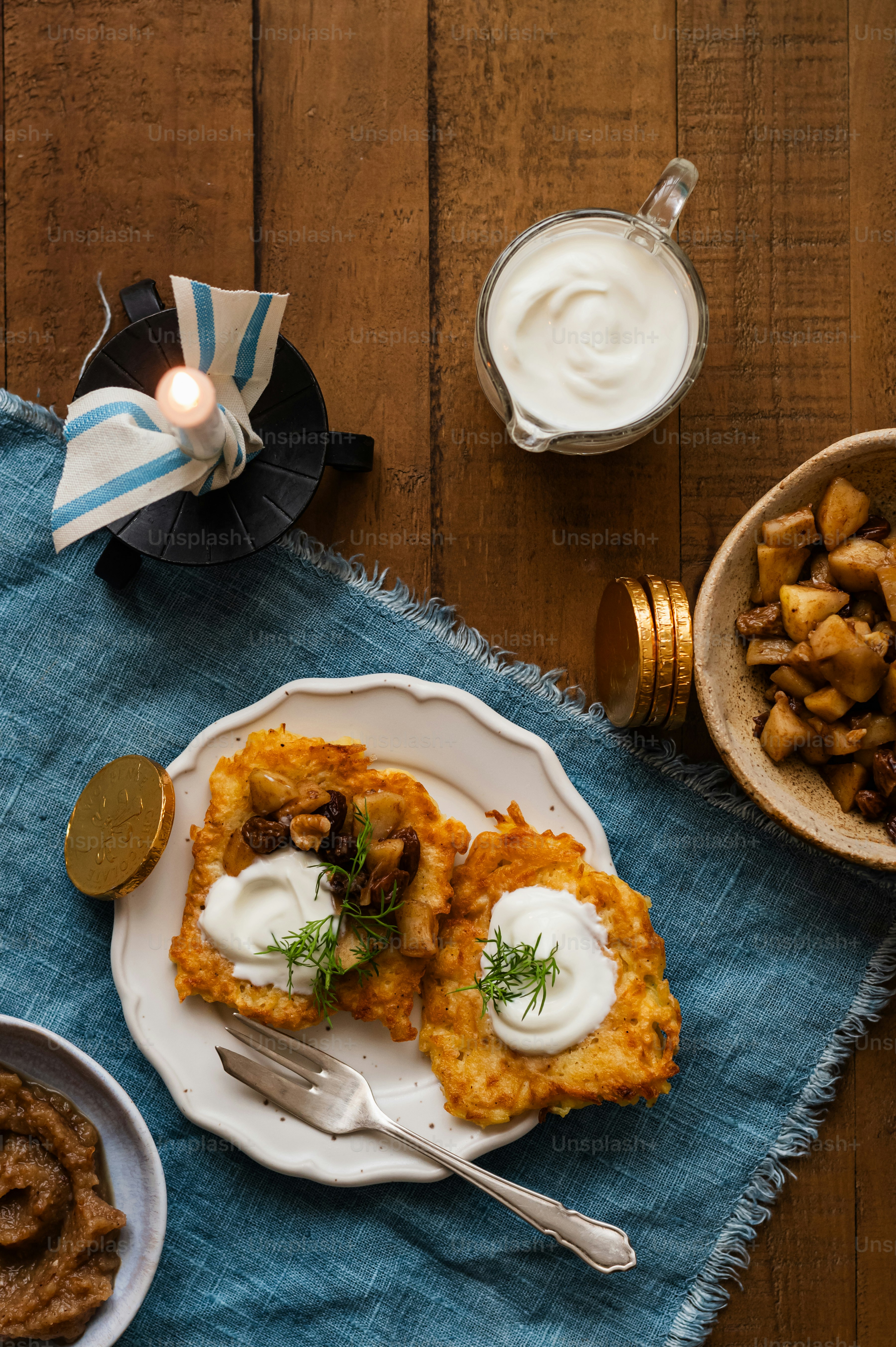 a white plate topped with food next to a bowl of food