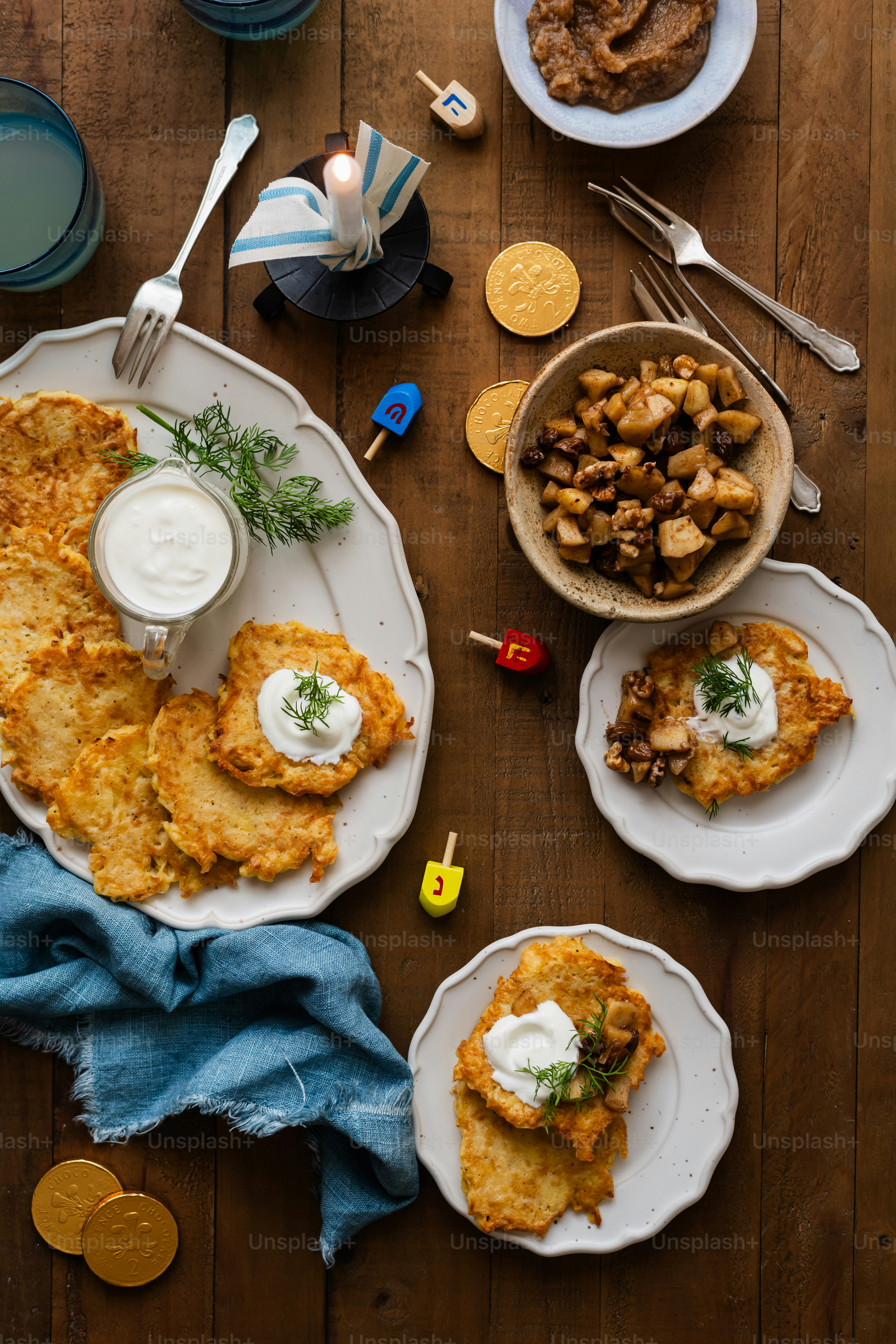 a wooden table topped with plates of food