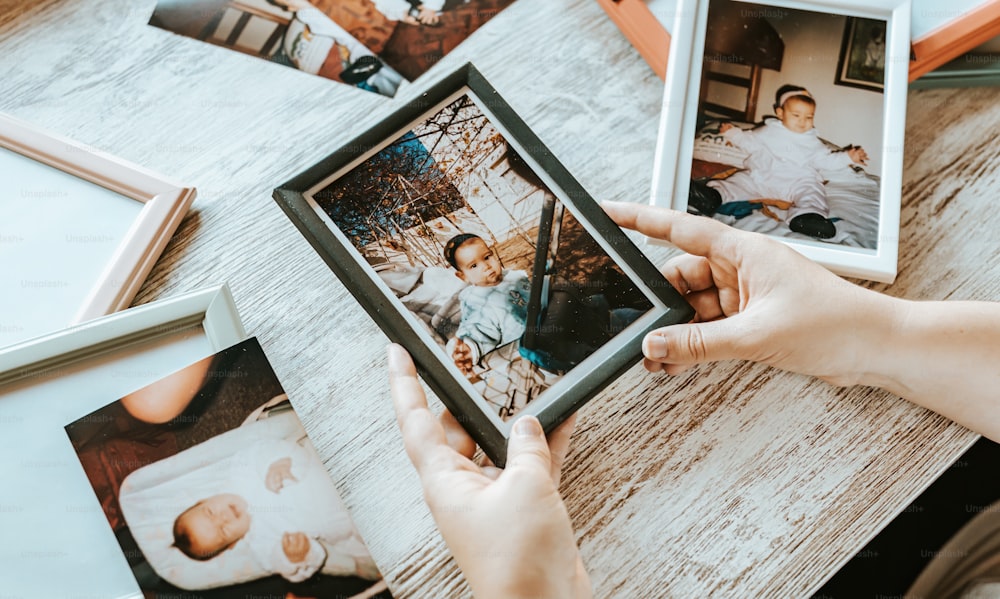 a person holding a picture of a family