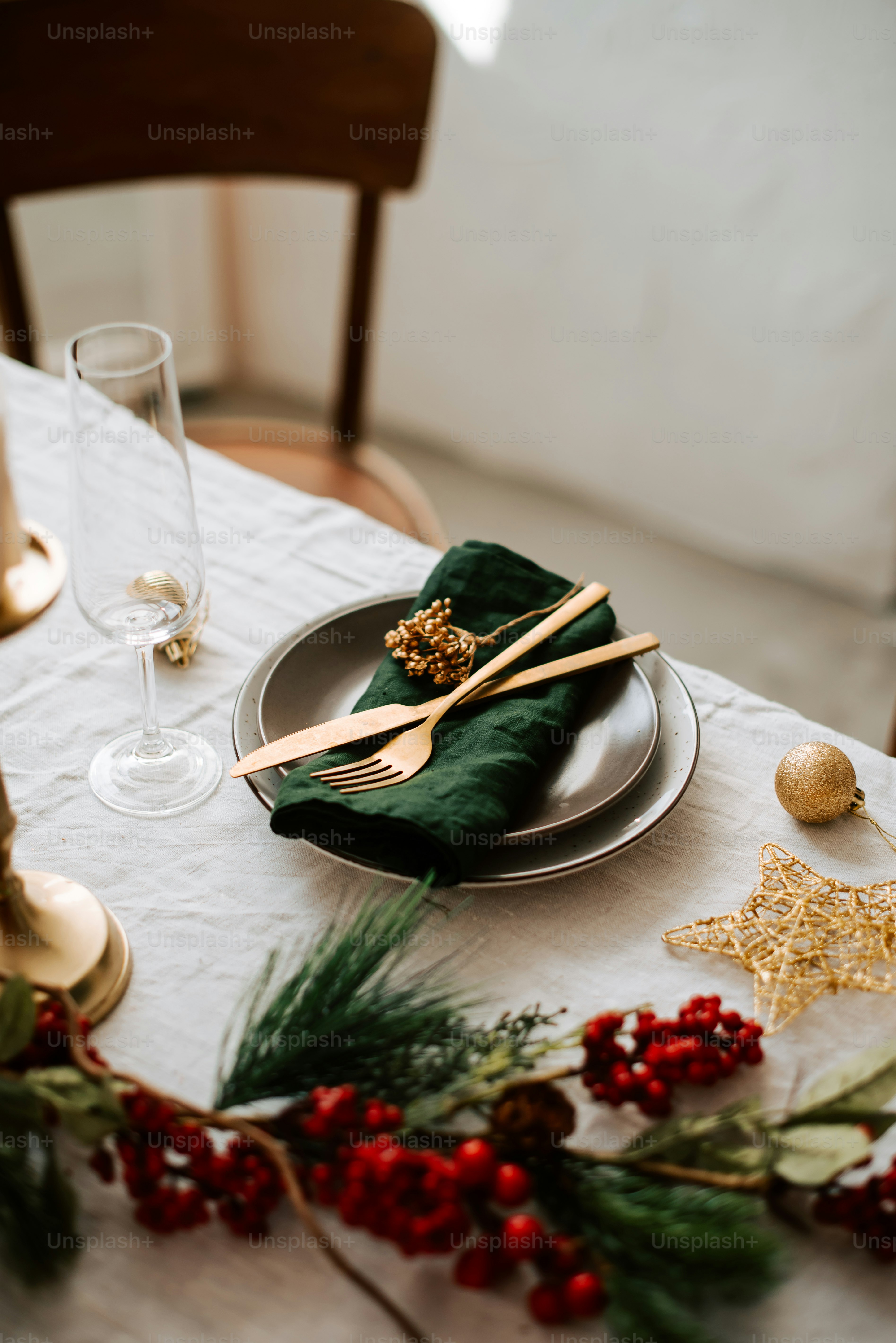 a table with a white table cloth and gold place settings