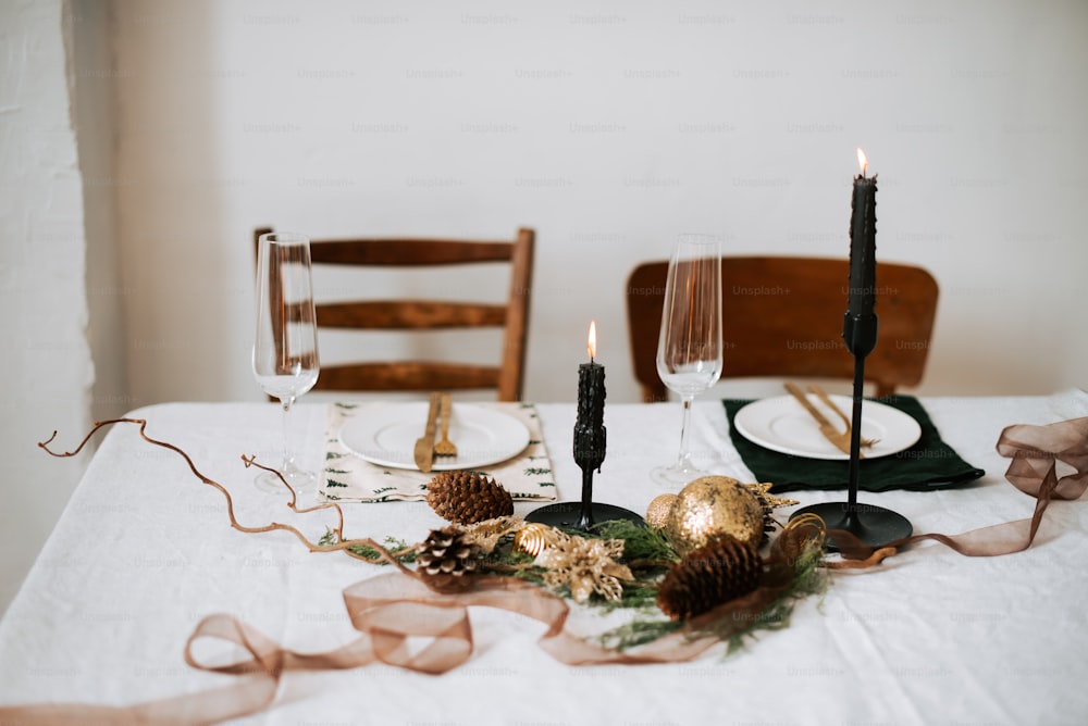 a table set for christmas with candles and decorations