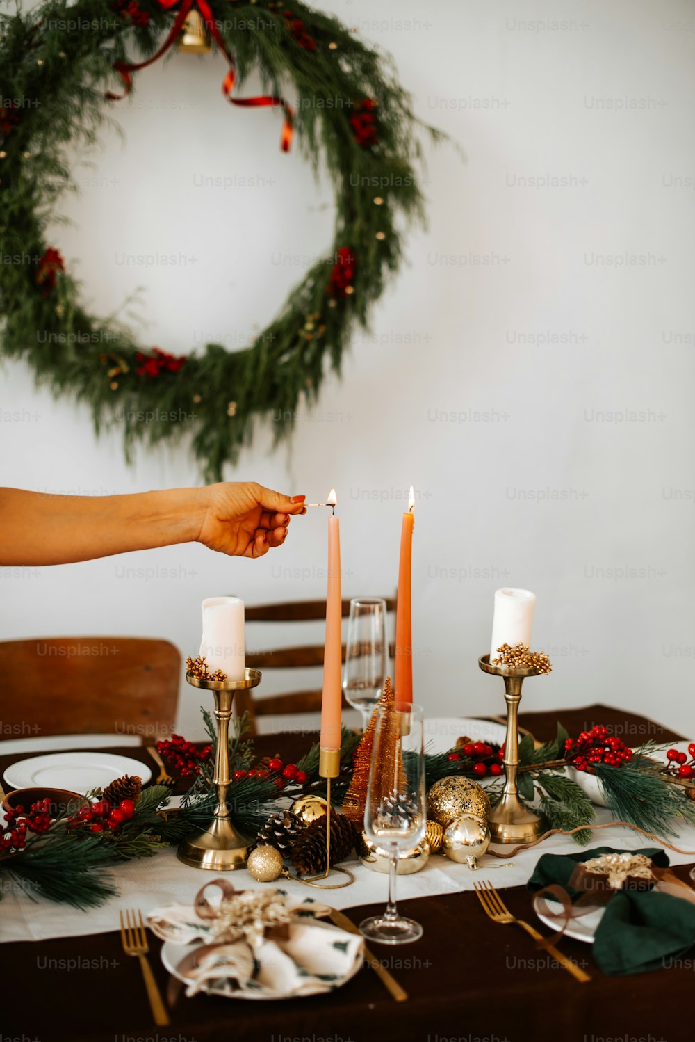 a woman setting a table for christmas dinner