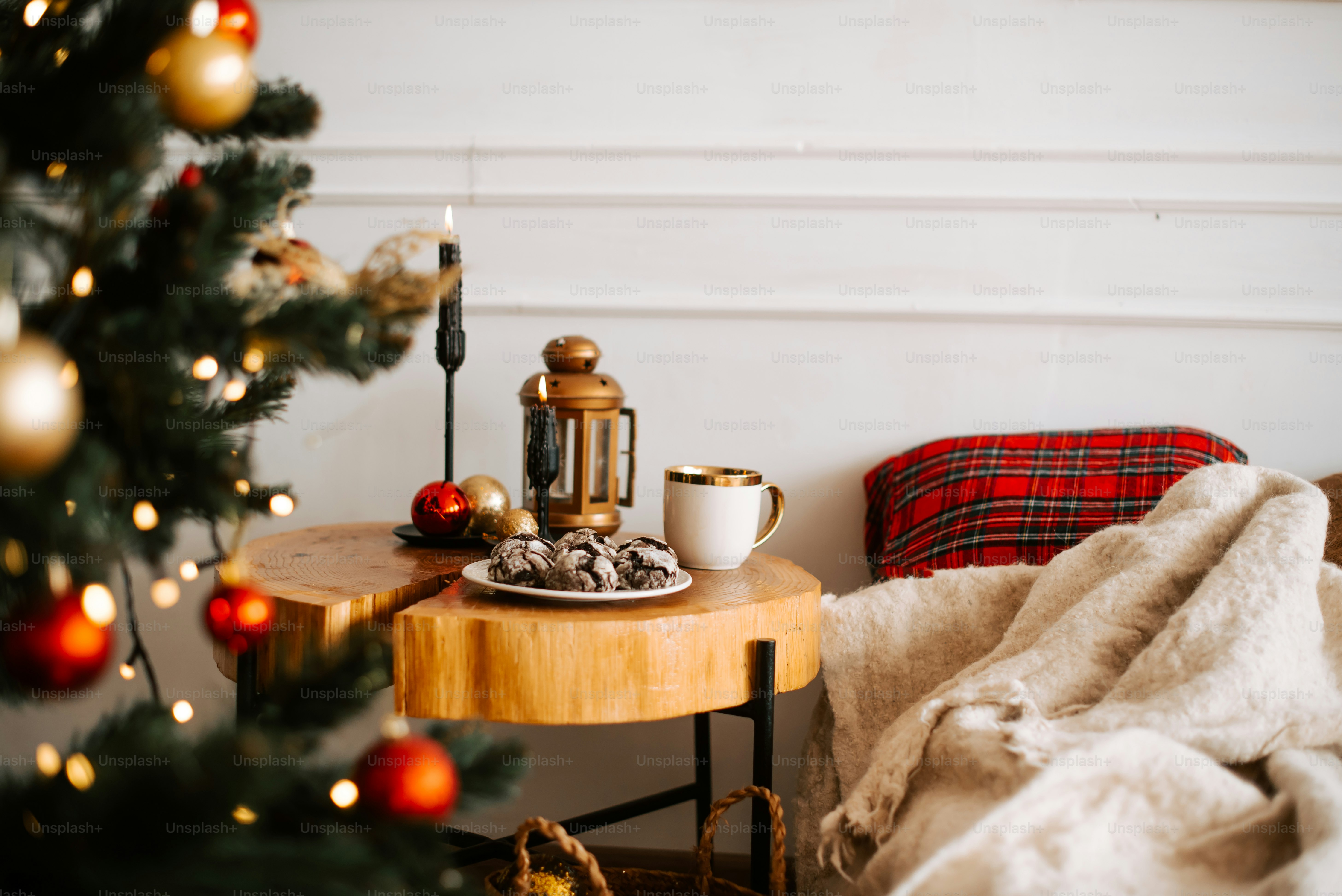 a table with a plate of cookies on it next to a christmas tree