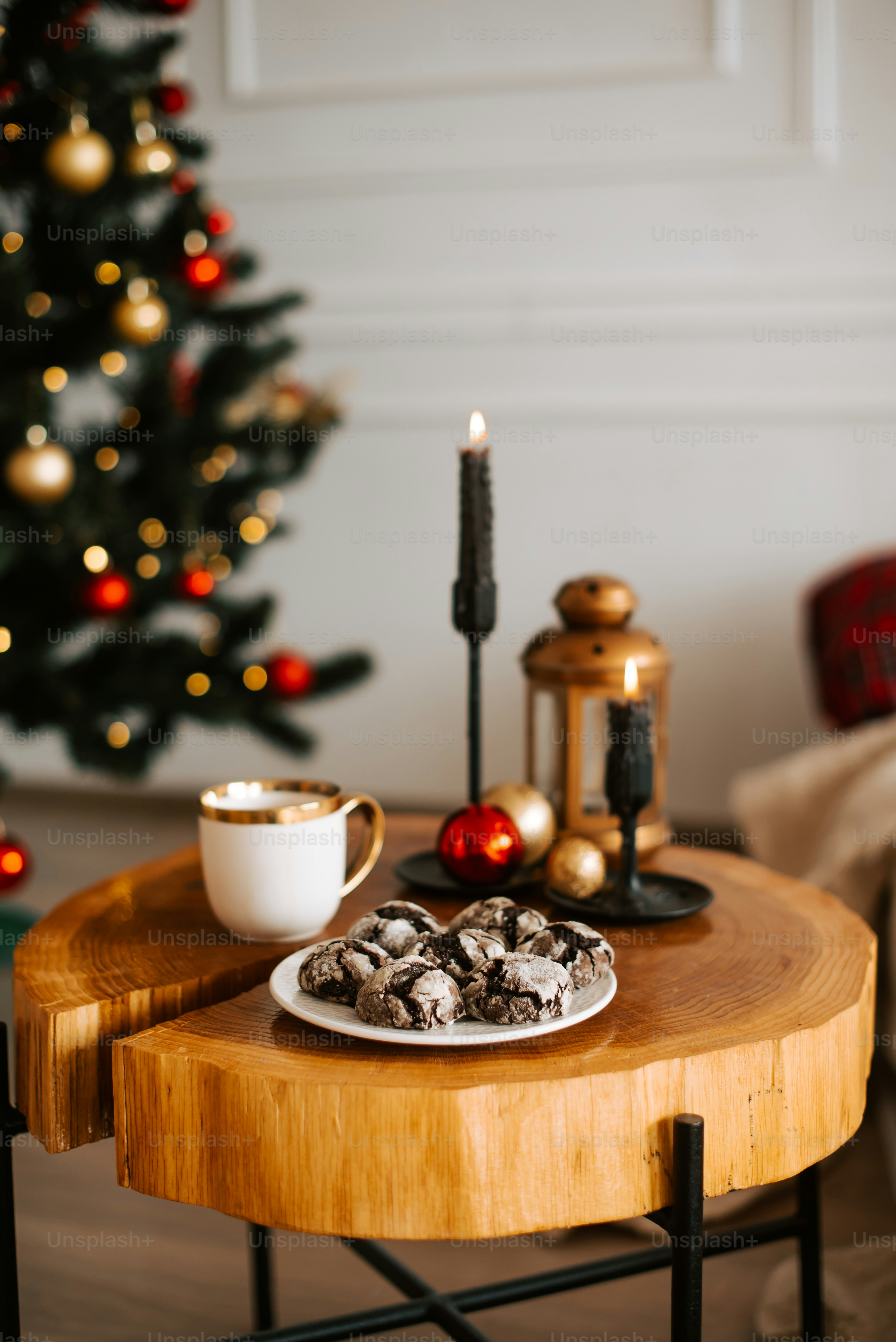 a wooden table topped with a plate of cookies and a cup of coffee