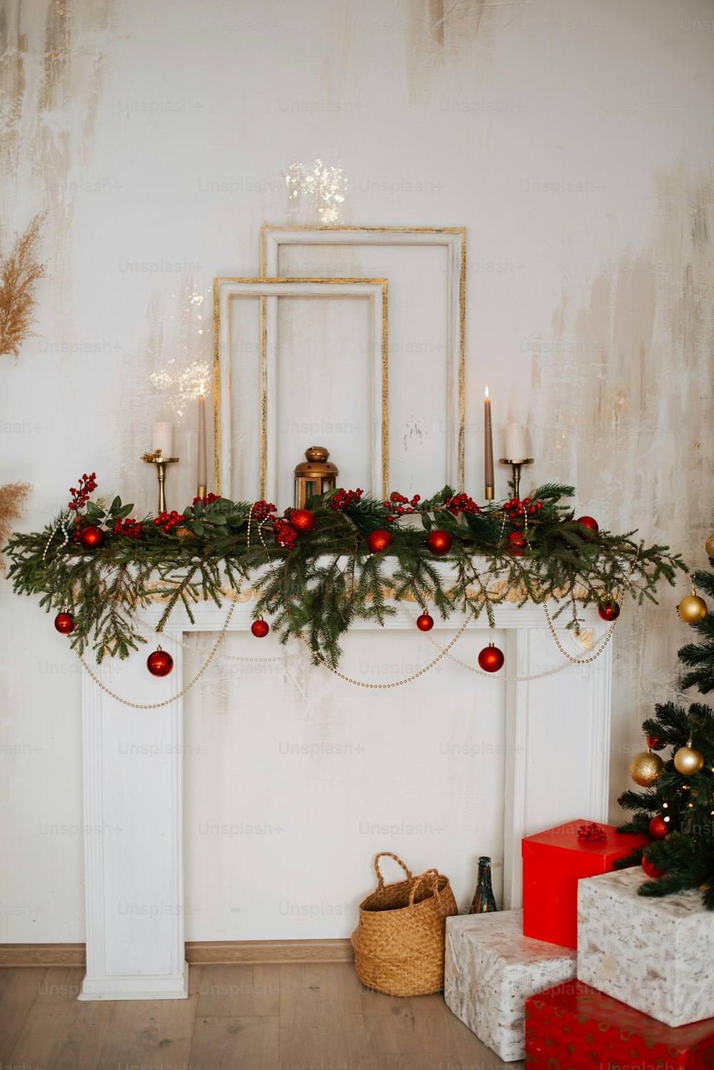 a mantel with a christmas garland and candles