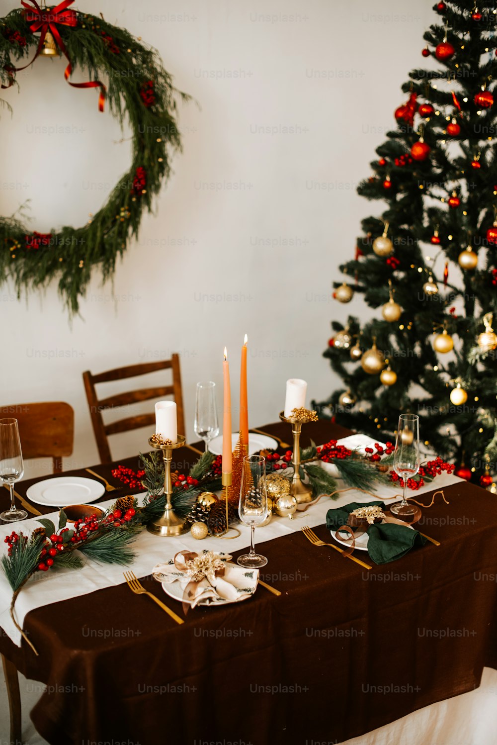 a christmas table setting with candles and decorations