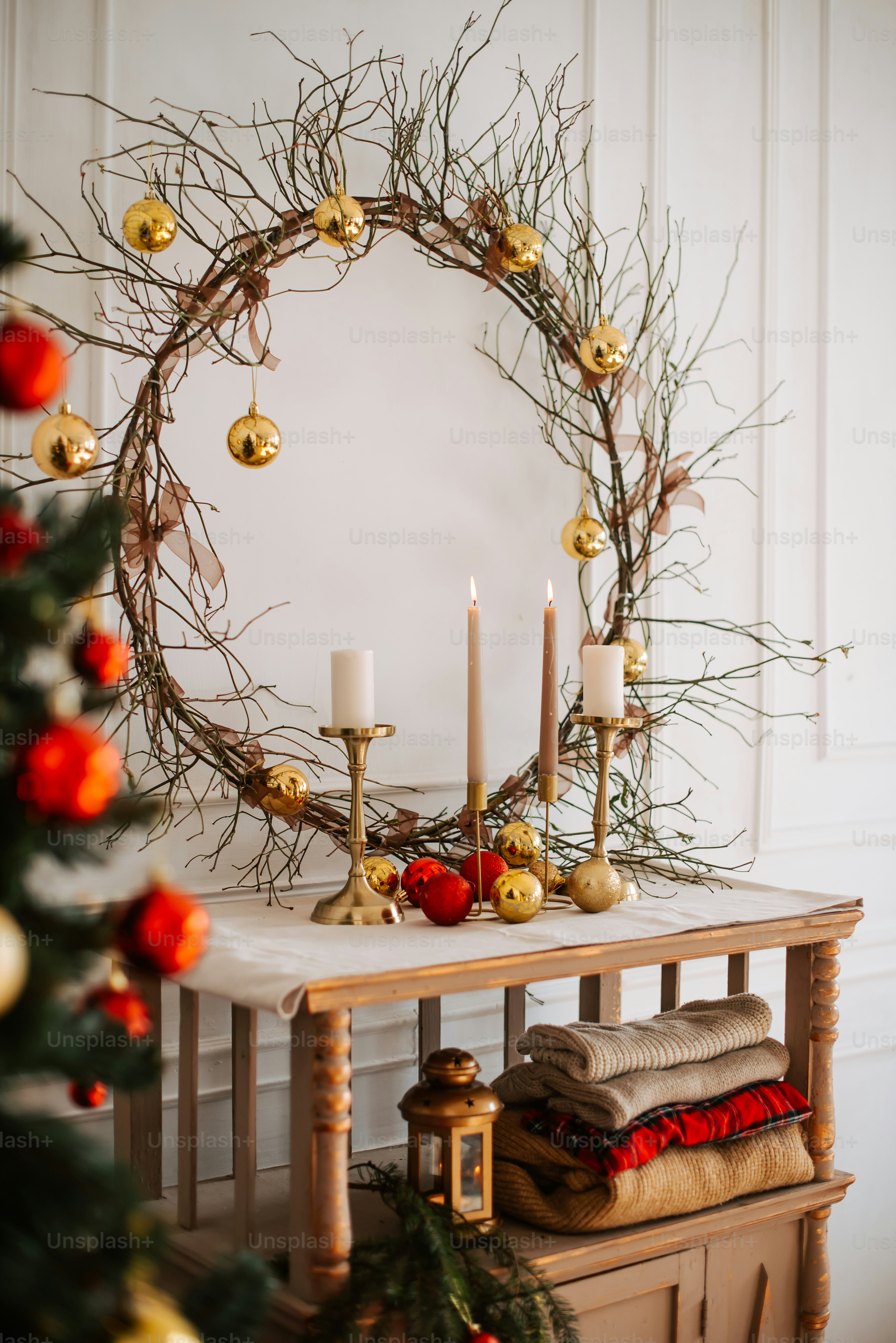 a table with a wreath and candles on it