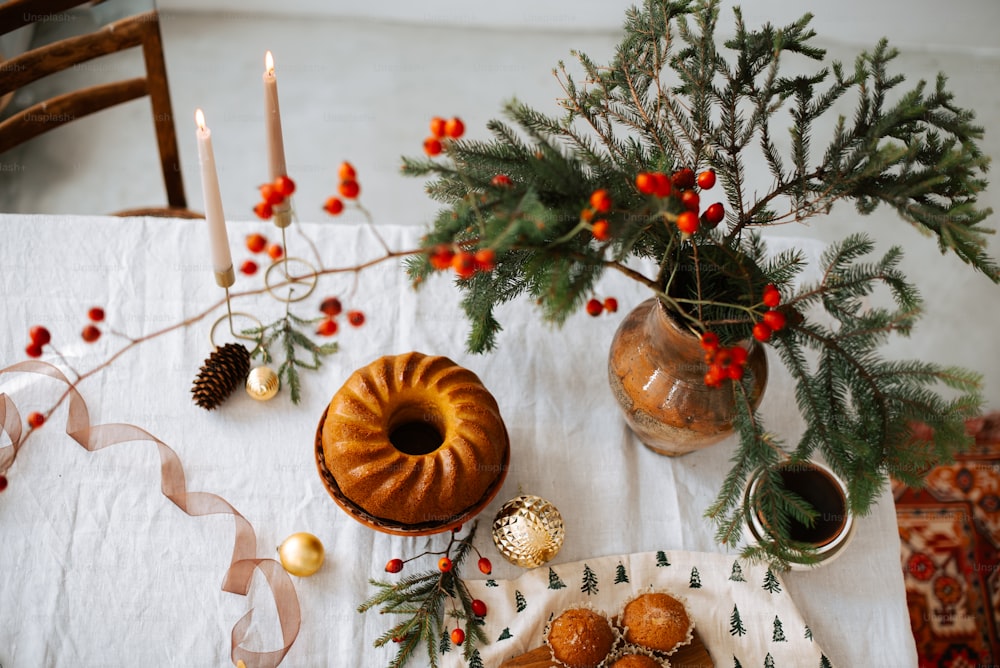 A table topped with a bundt cake next to a christmas tree photo ...