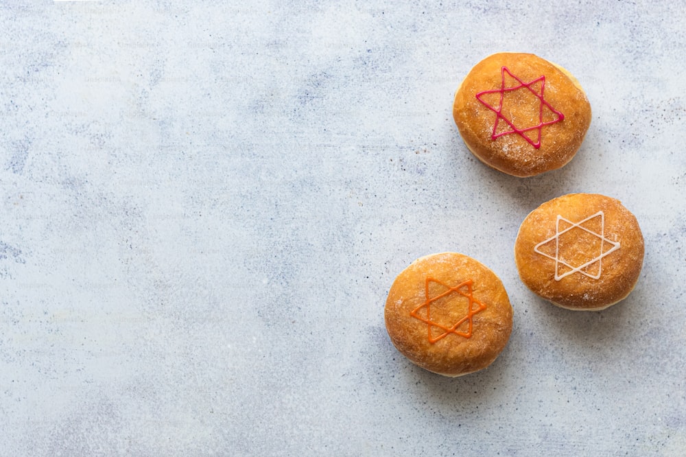 three orange muffins with red lines on them