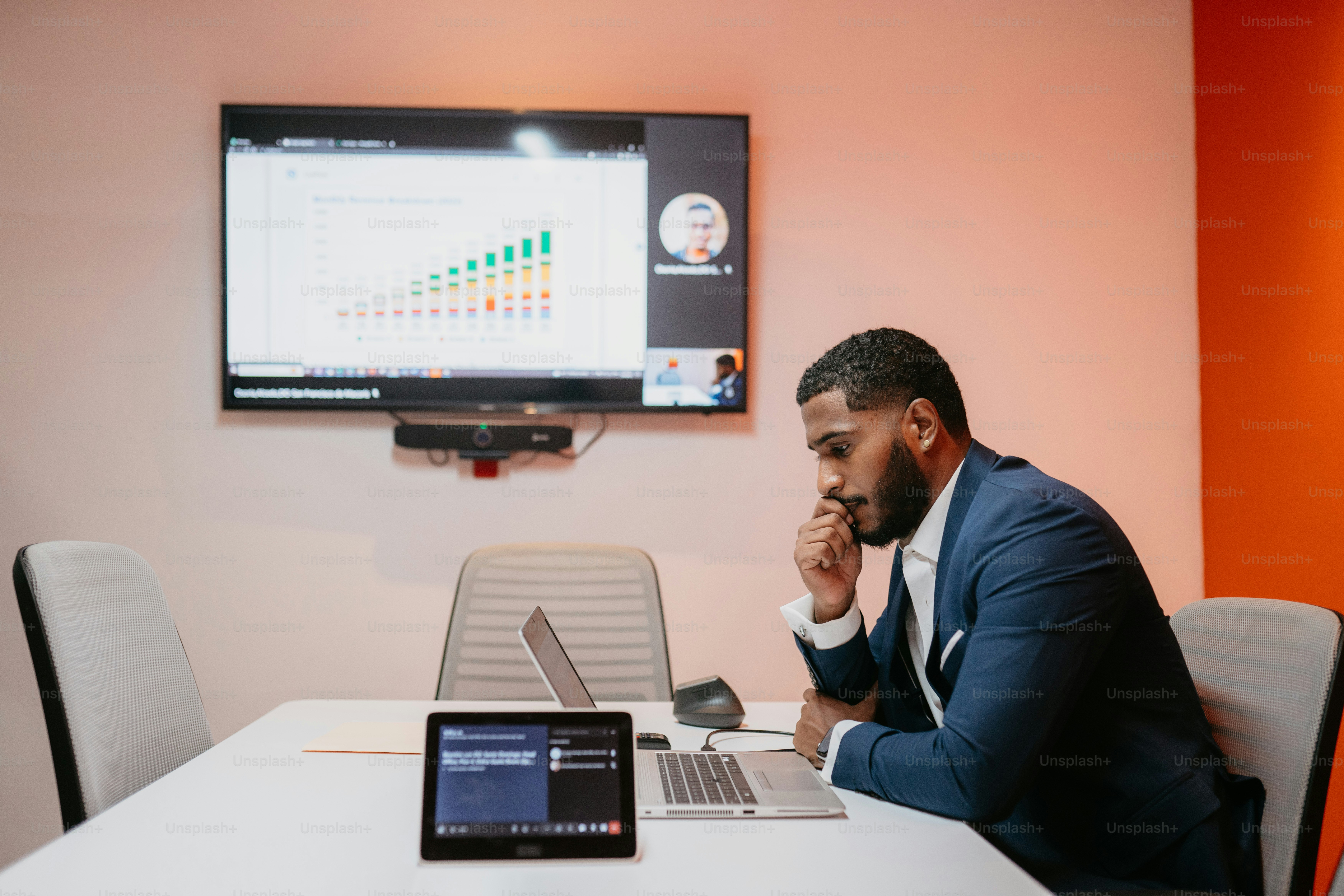 A man in a suit standing in front of a computer photo – Office Image on ...