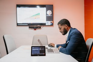 a man sitting in front of a laptop computer