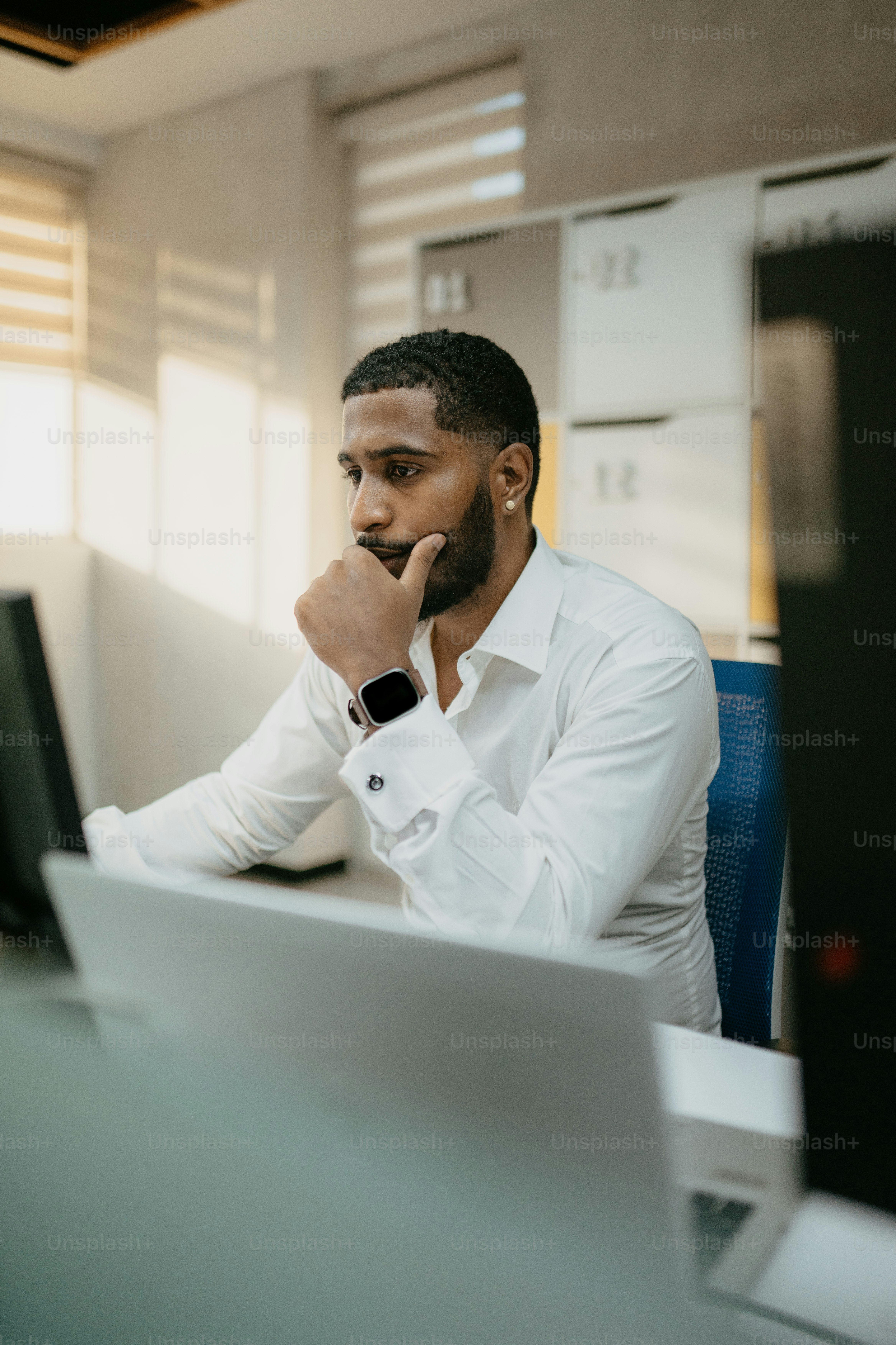 a man sitting at a desk in front of a computer