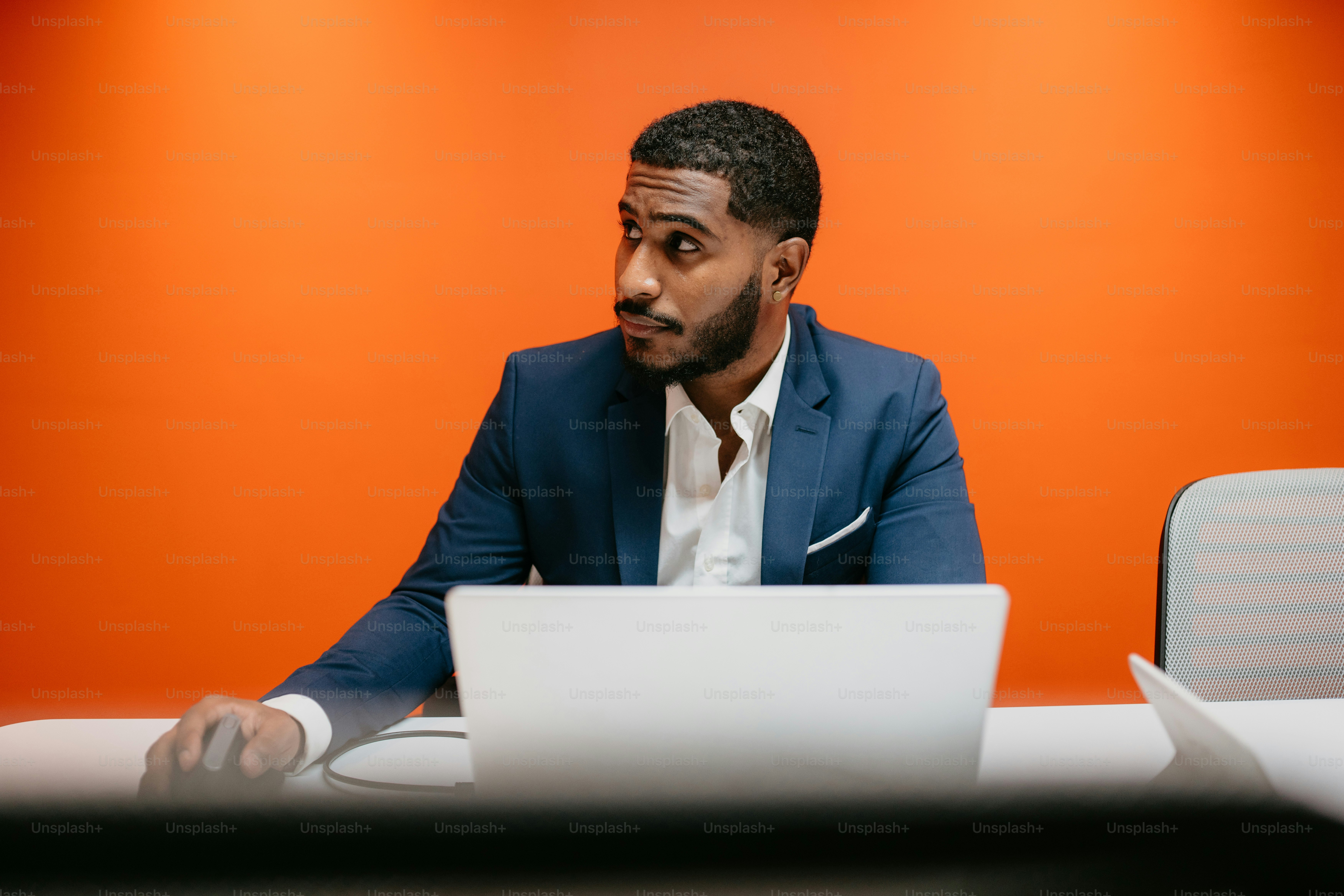 A man in a suit standing in front of a computer photo – Office Image on ...