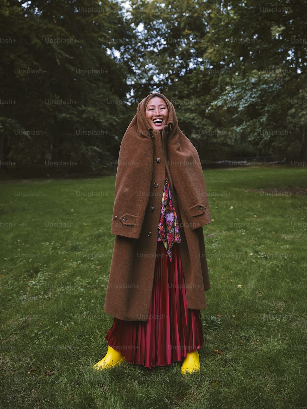 a woman in a red dress and a brown coat