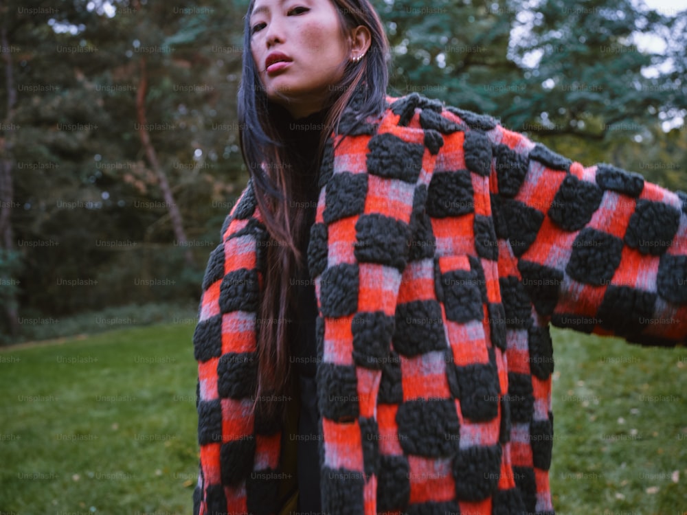 a woman in a red and black checkered coat