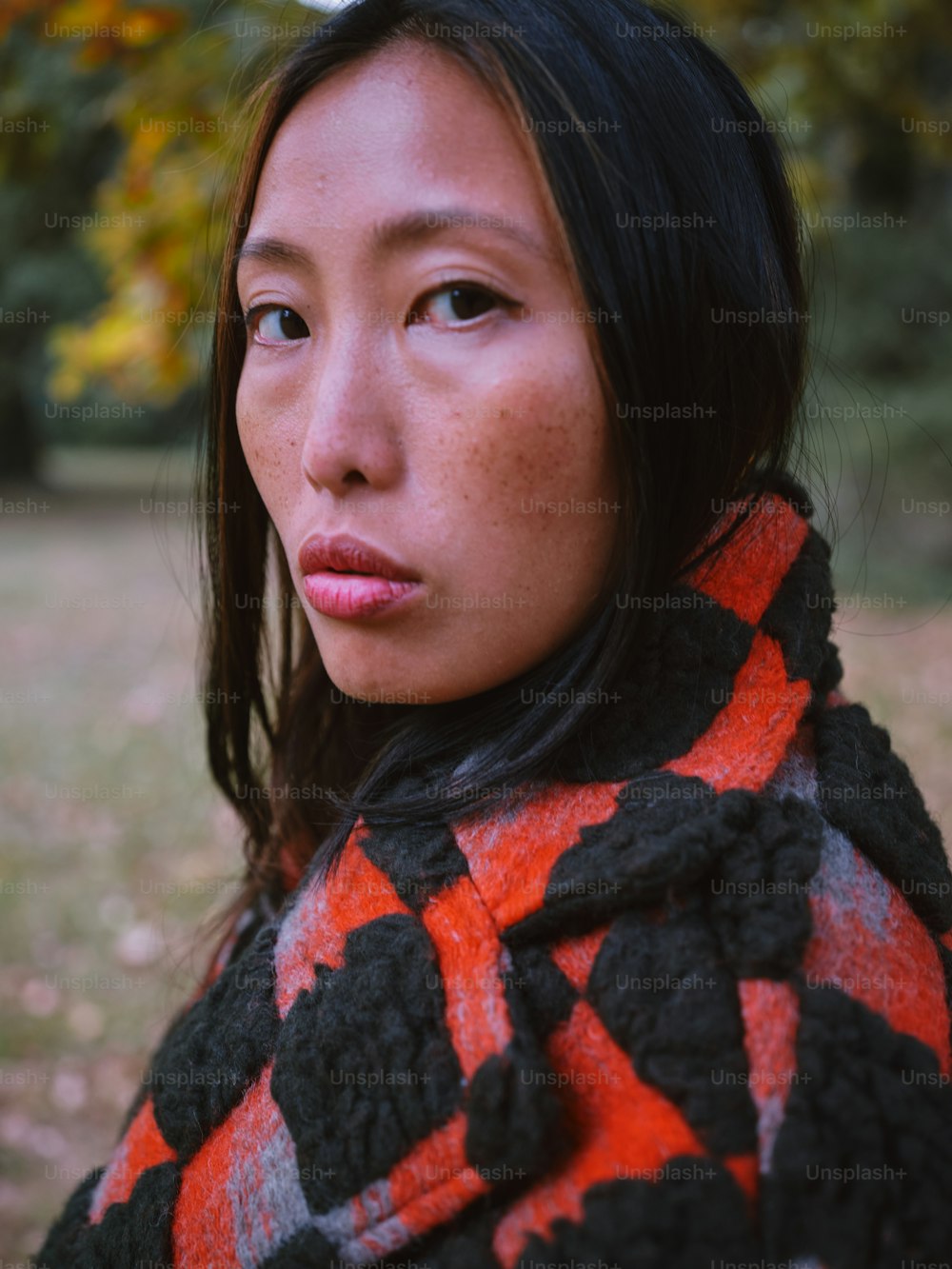 a close up of a person wearing a scarf
