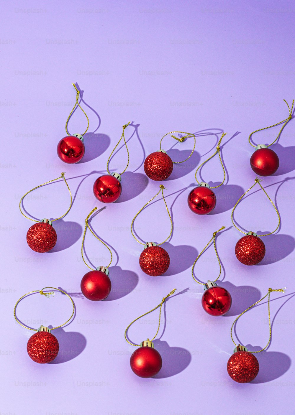 a bunch of red ornaments hanging from a string