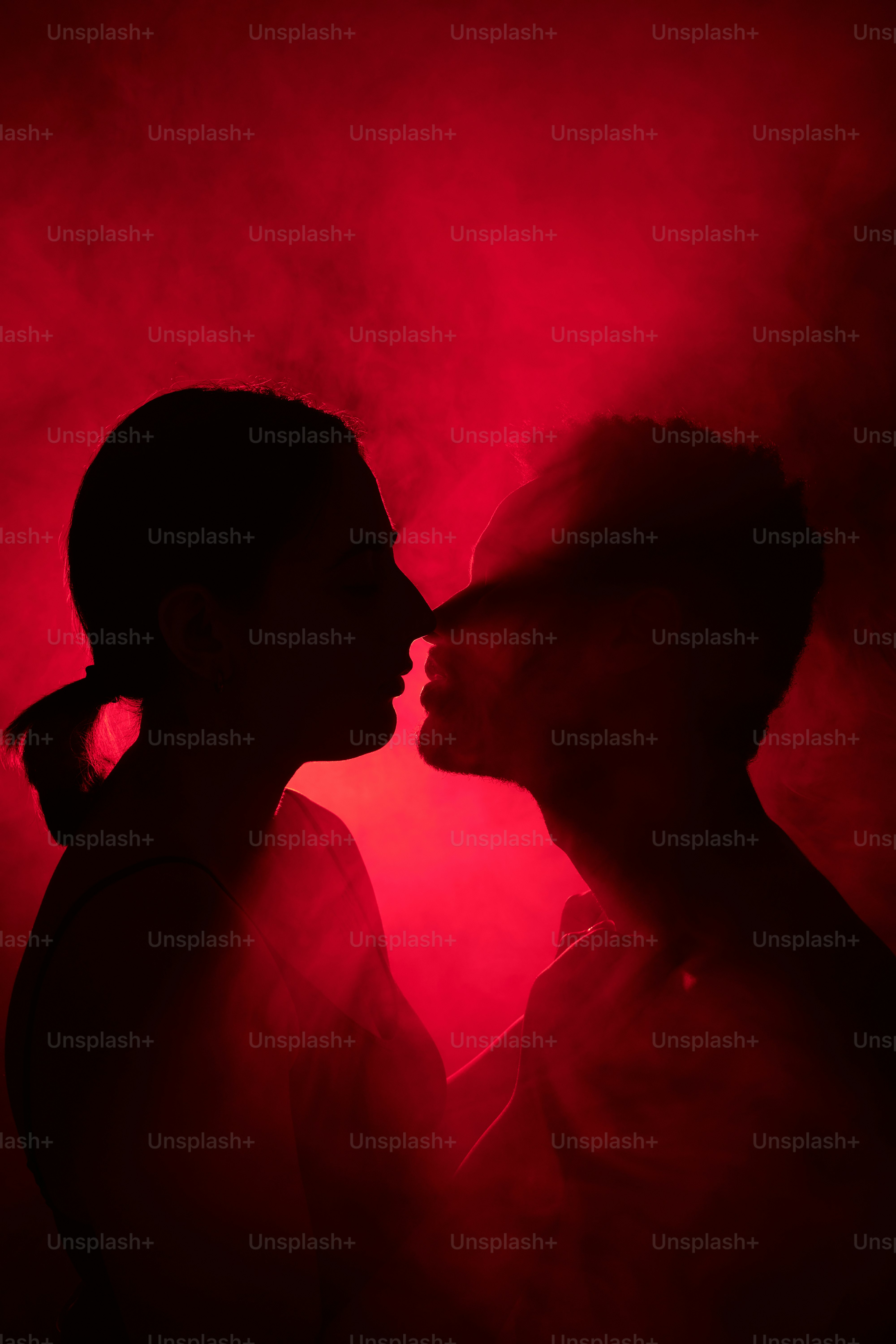 a man and a woman kissing in the dark