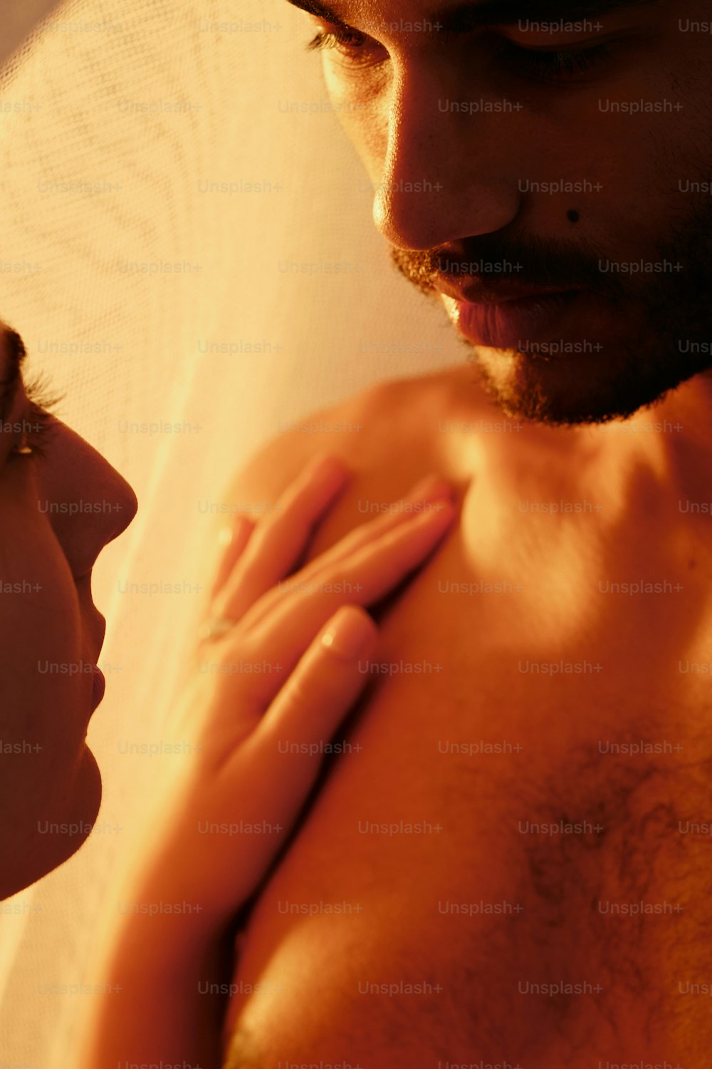 a close up of a man and a woman looking at each other