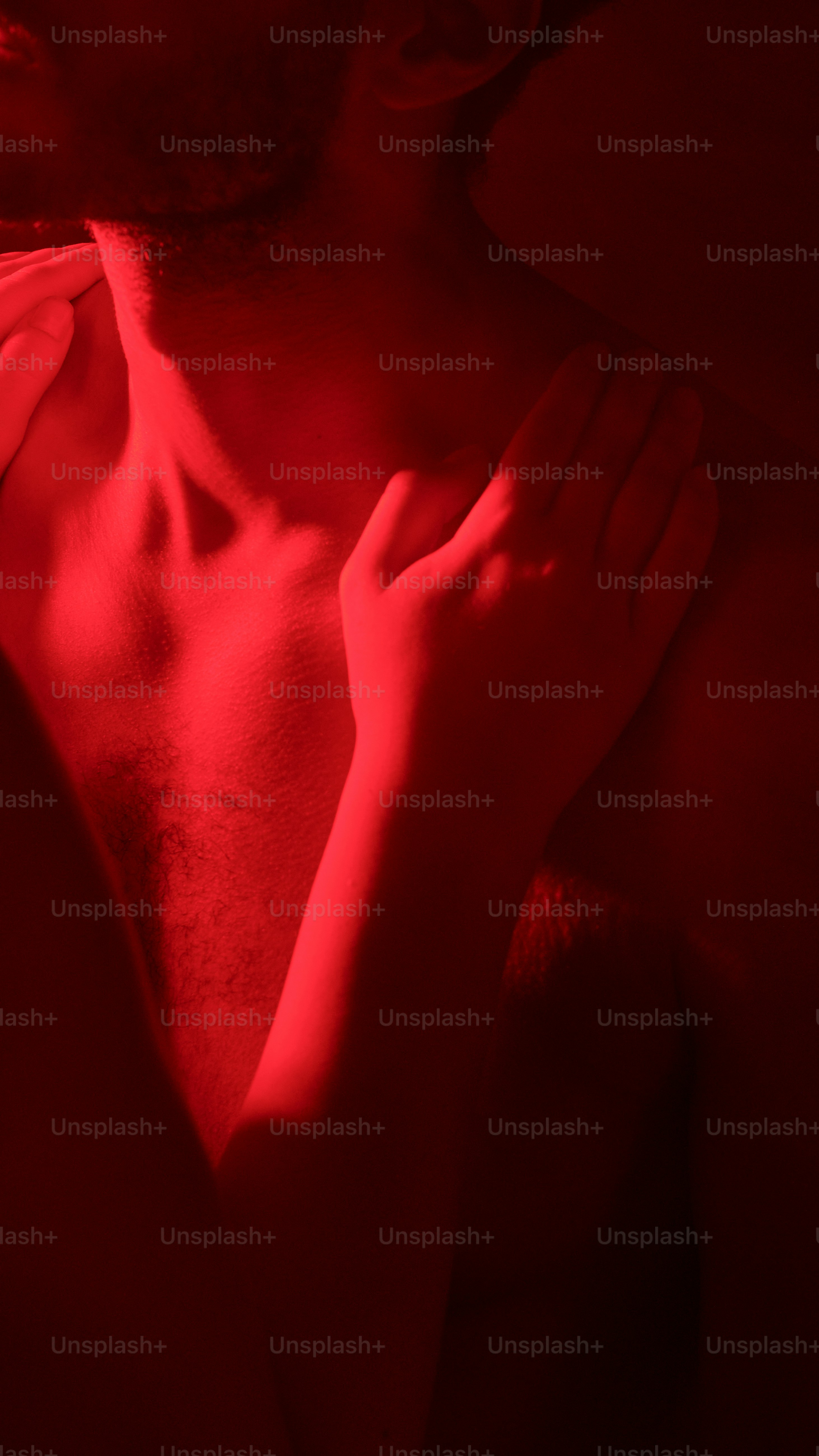 a shirtless man with his hands on his chest