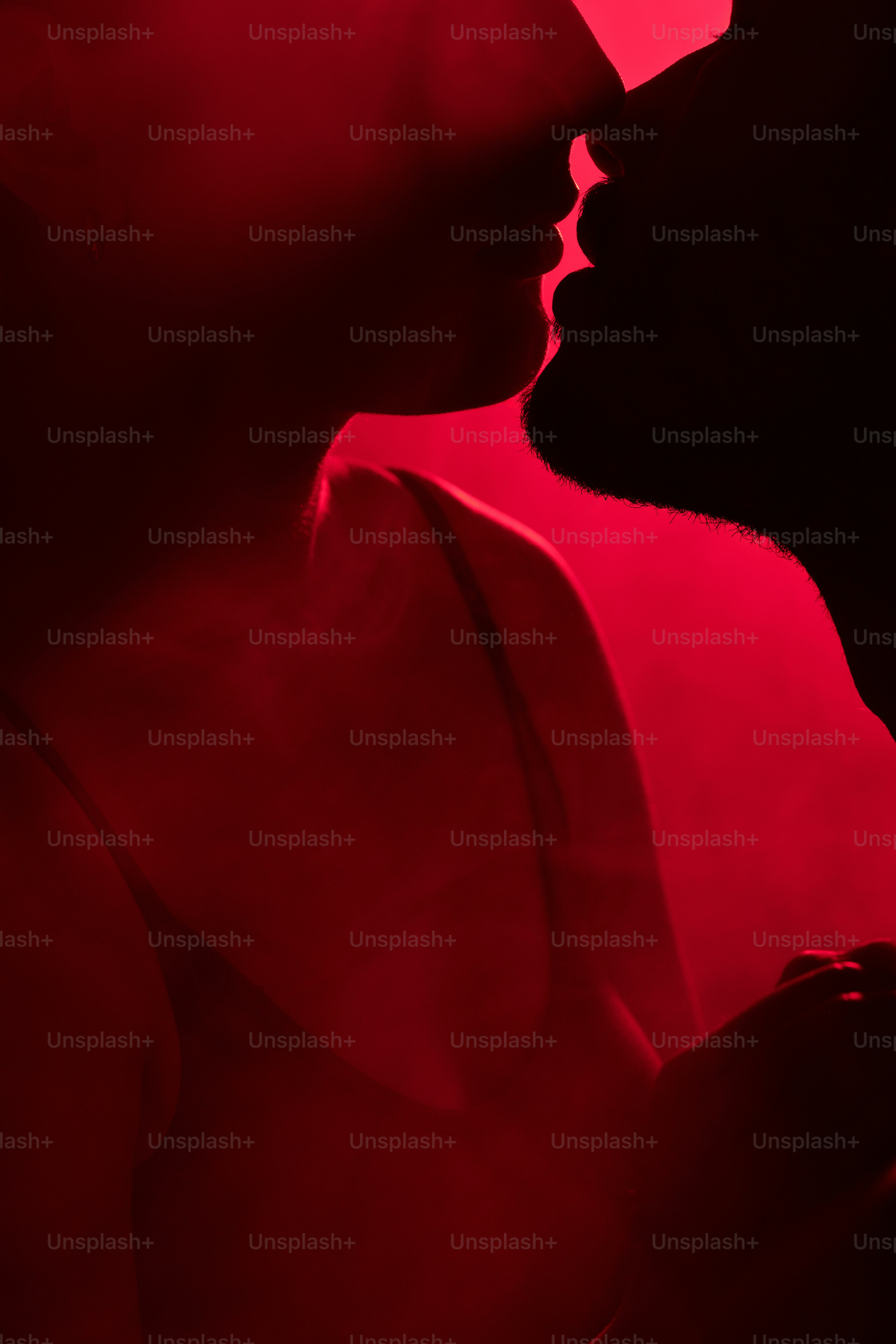 a man and a woman kissing in the dark