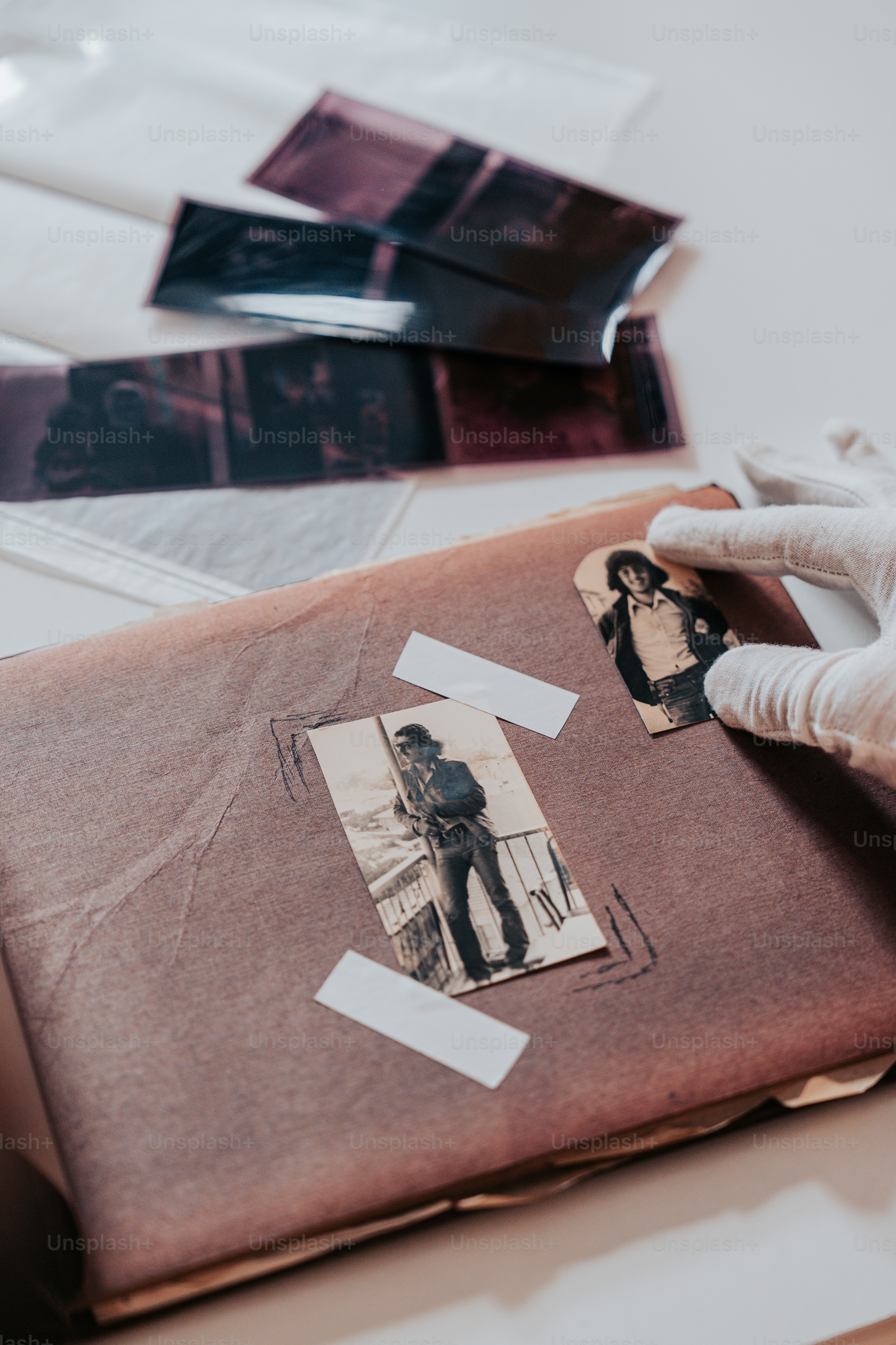 a person in white gloves and gloves holding a piece of paper