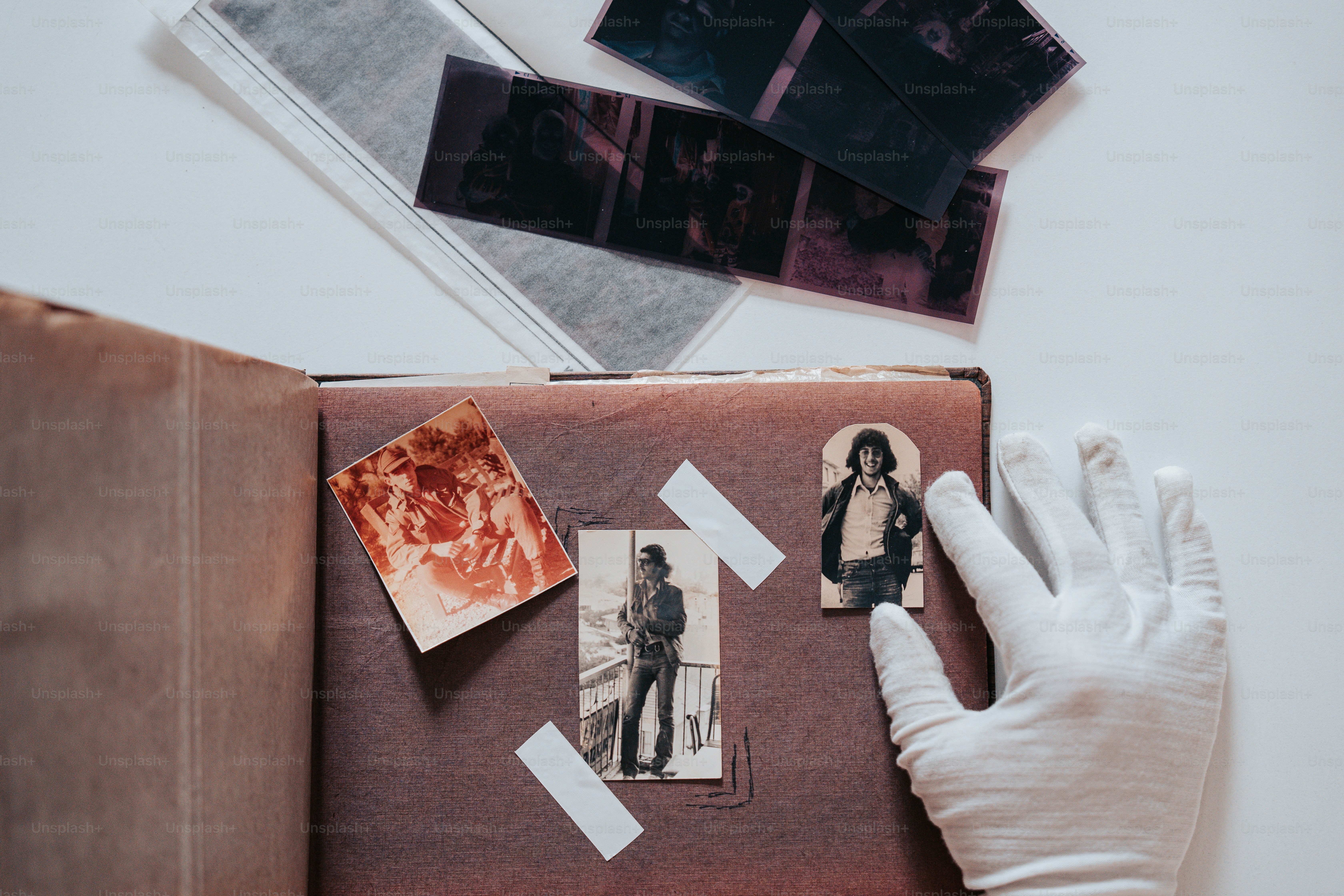 a person in white gloves holding a book