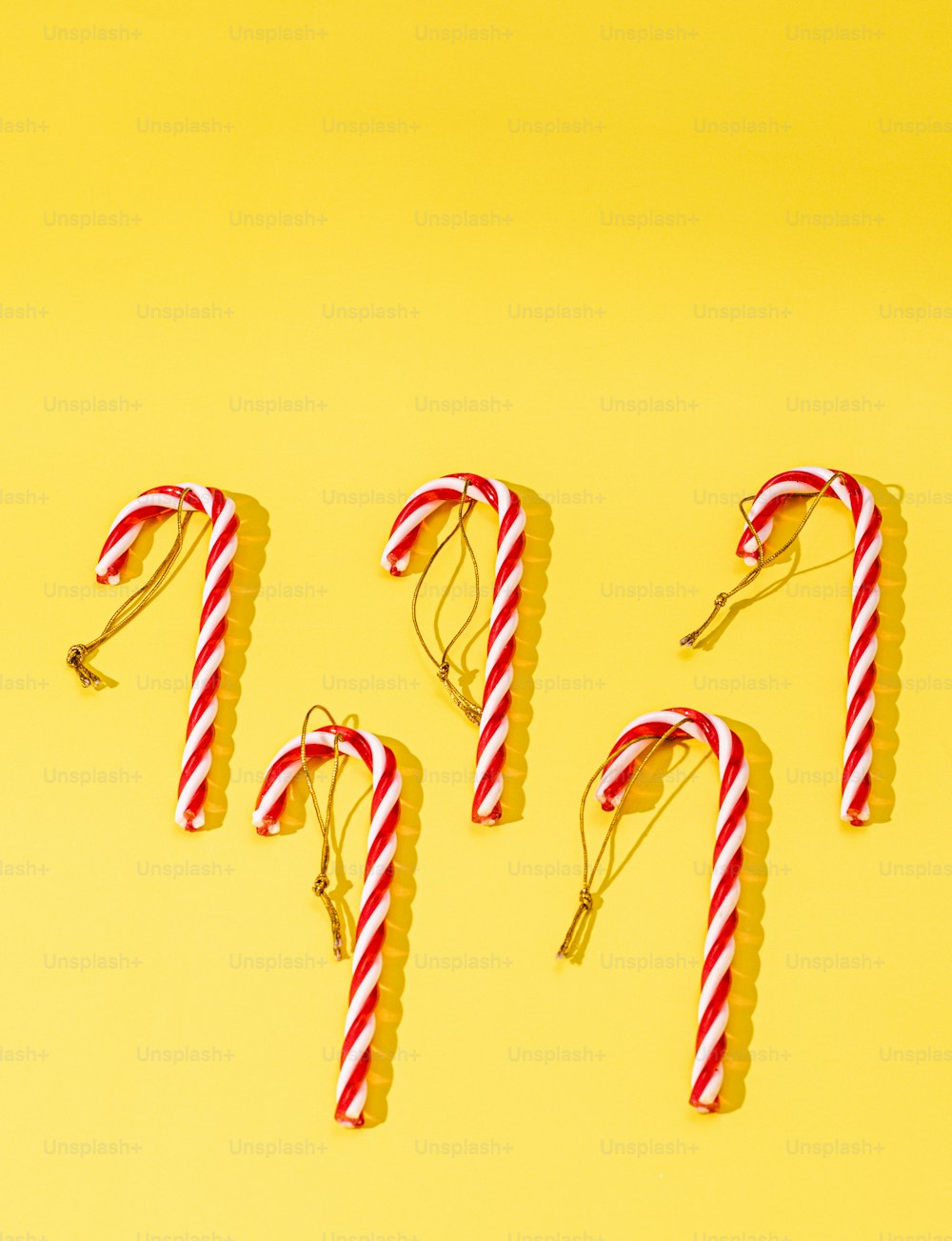 a group of candy canes sitting on top of a yellow surface