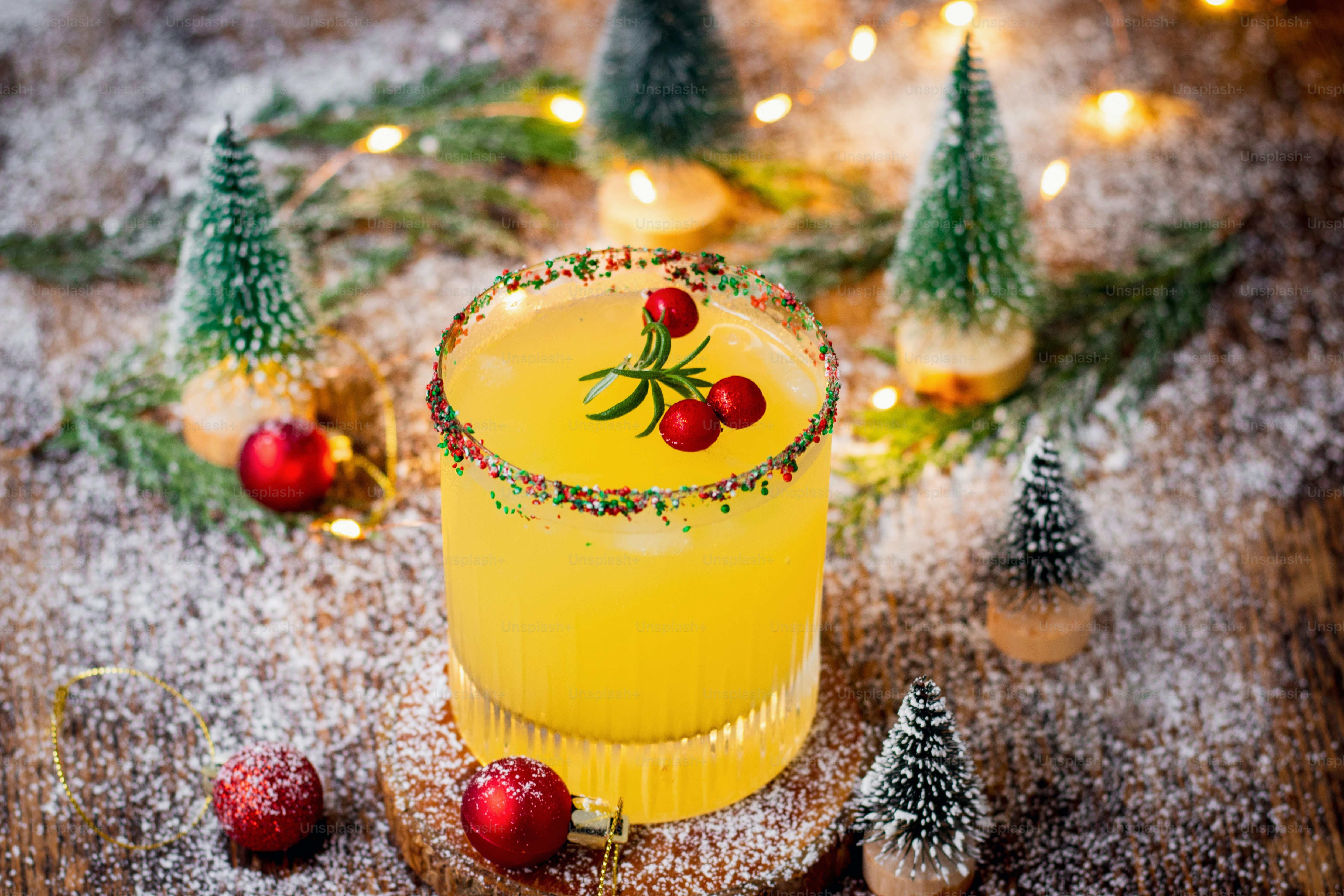 a yellow cocktail sitting on top of a wooden table