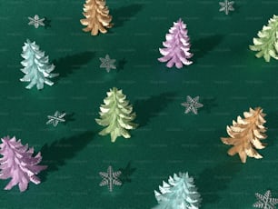 a group of christmas trees sitting on top of a green surface