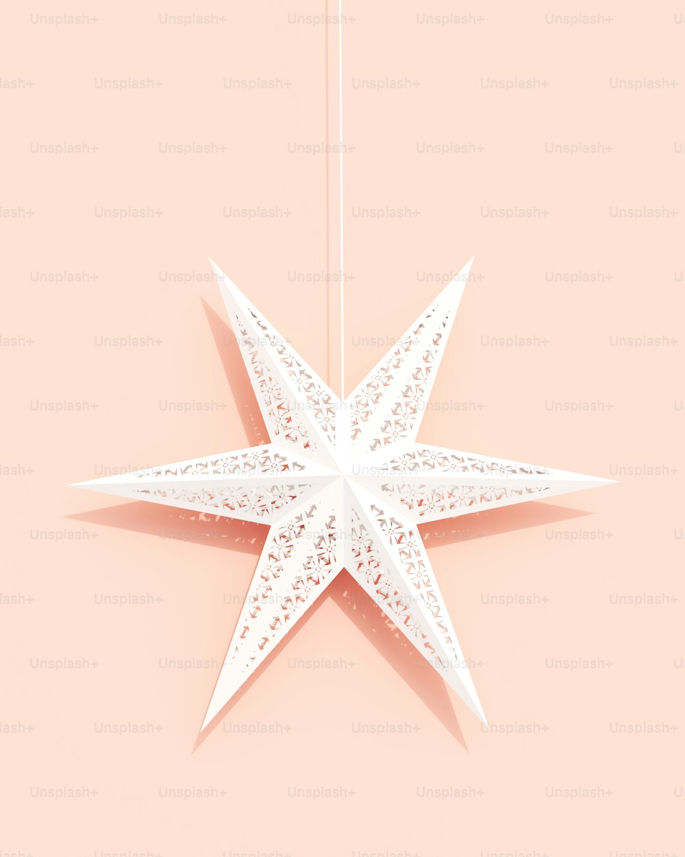 Una stella origami bianca appesa a una corda