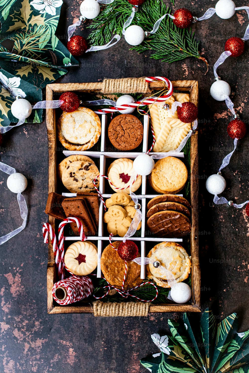 a wooden box filled with cookies and candy canes