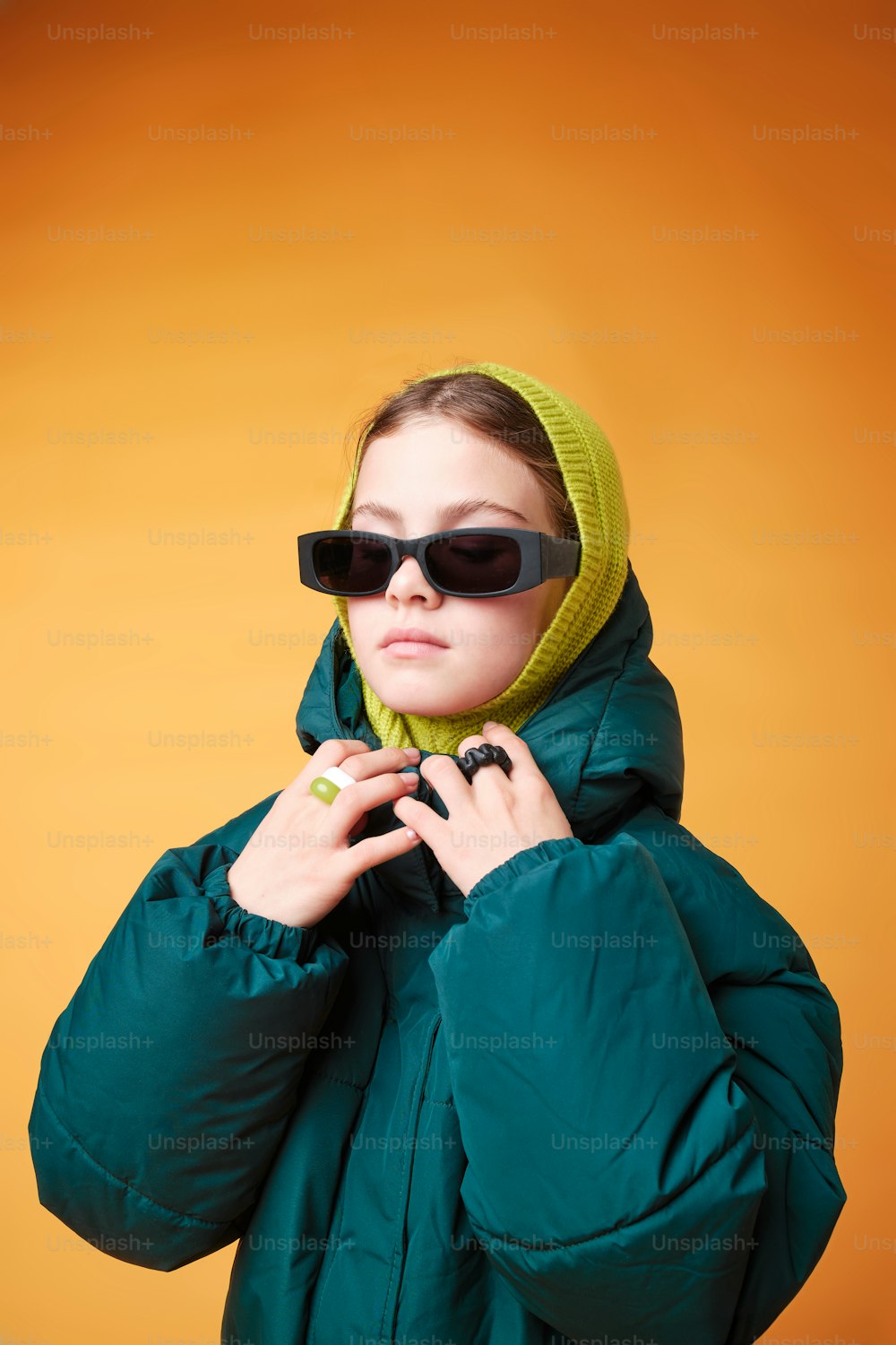 a woman wearing sunglasses and a green jacket