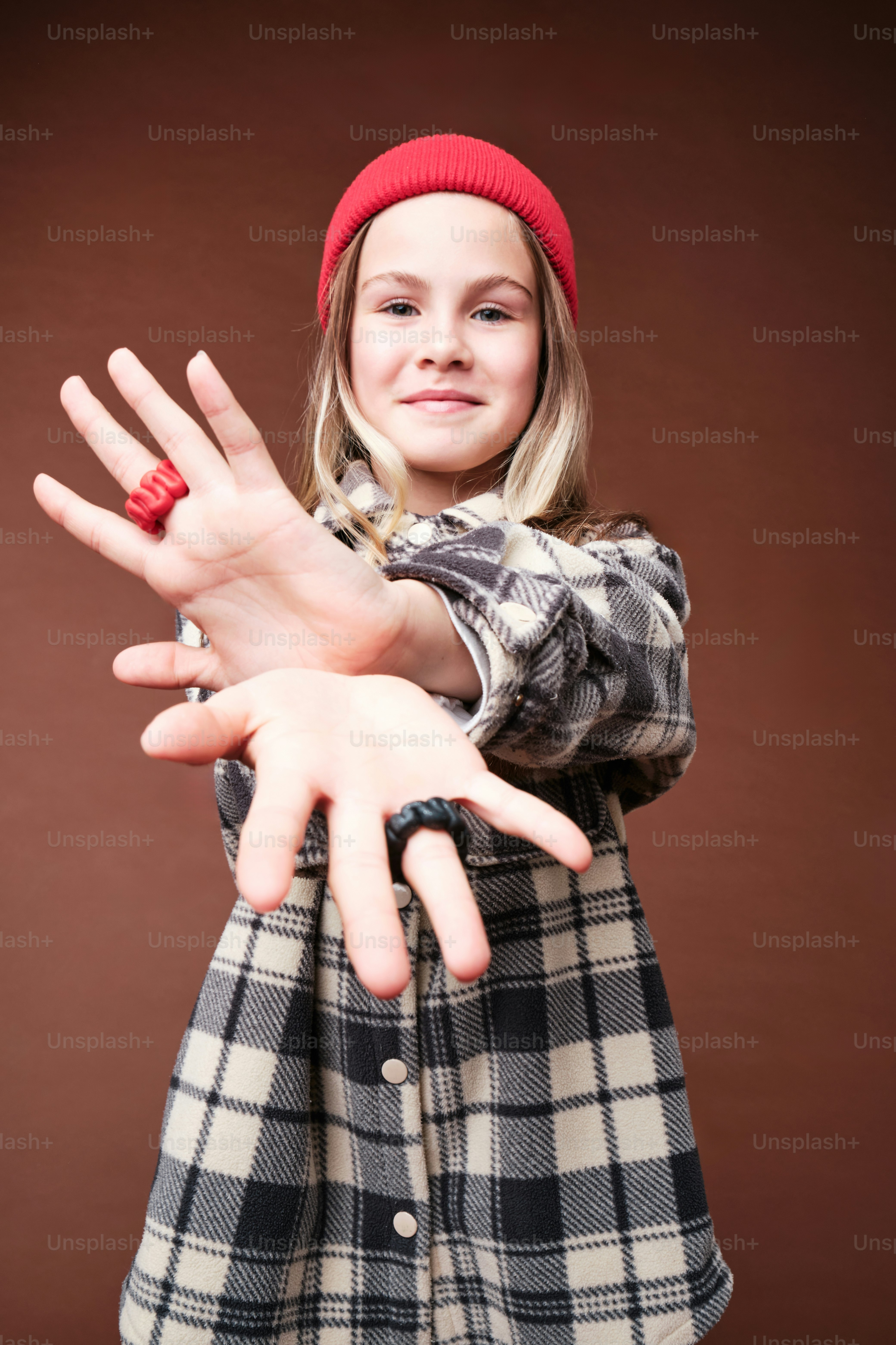 A girl in autumn clothes on studio background in warm color scheme