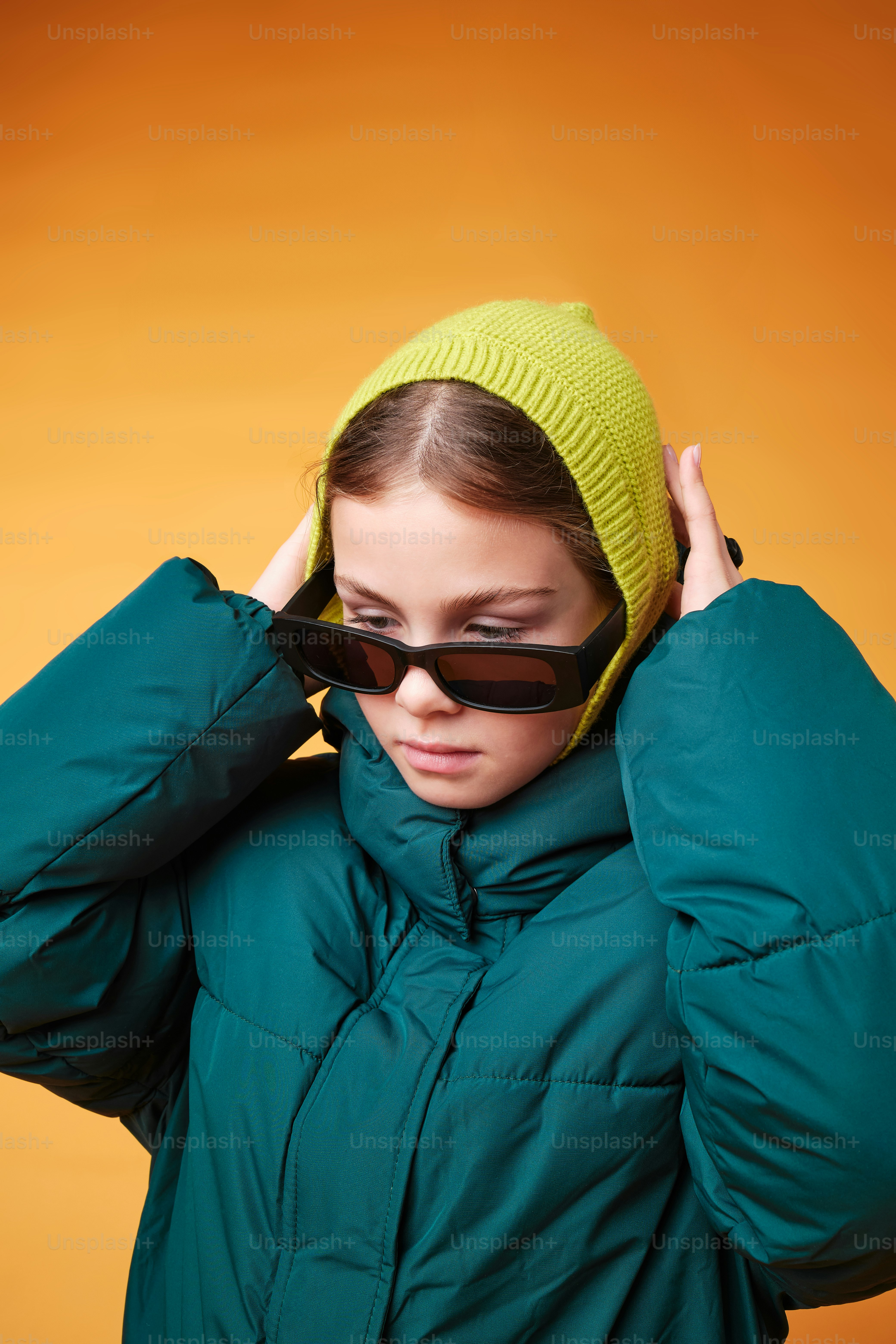 a woman wearing a green jacket and a green hat