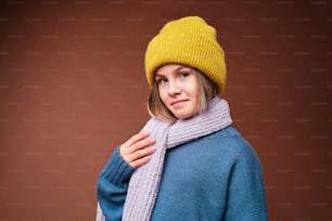 a woman wearing a yellow hat and scarf