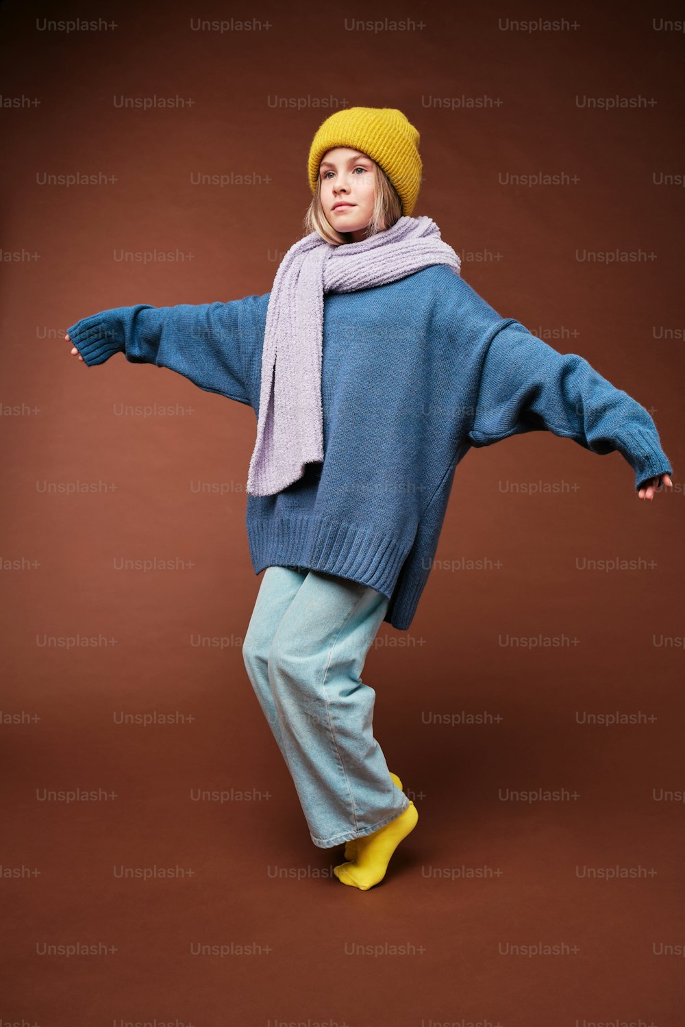 a woman in a blue sweater and yellow boots